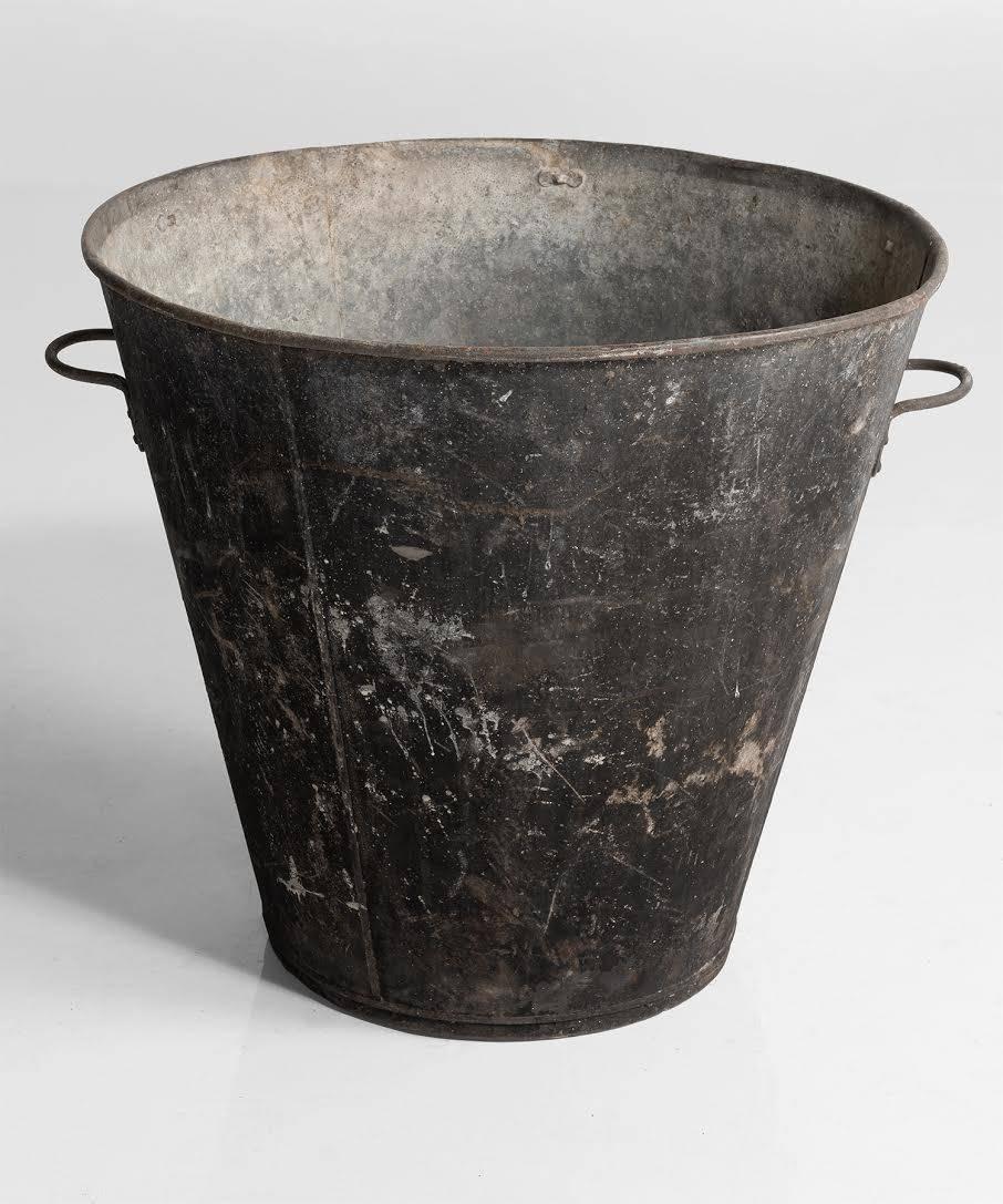 Industrial black bucket, England, circa 1940.

Wonderfully patinated black exterior with two handles.