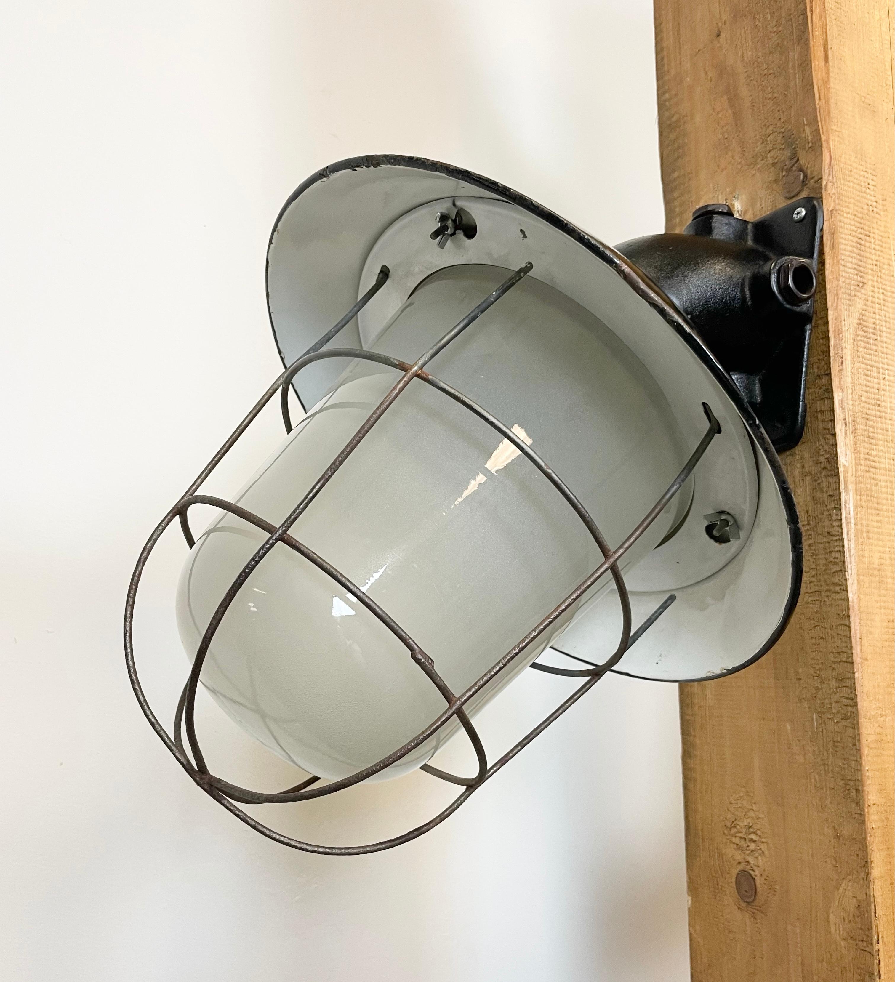 Czech Industrial Black Enamel and Cast Iron Wall Lamp with Iron Grid, 1960s For Sale