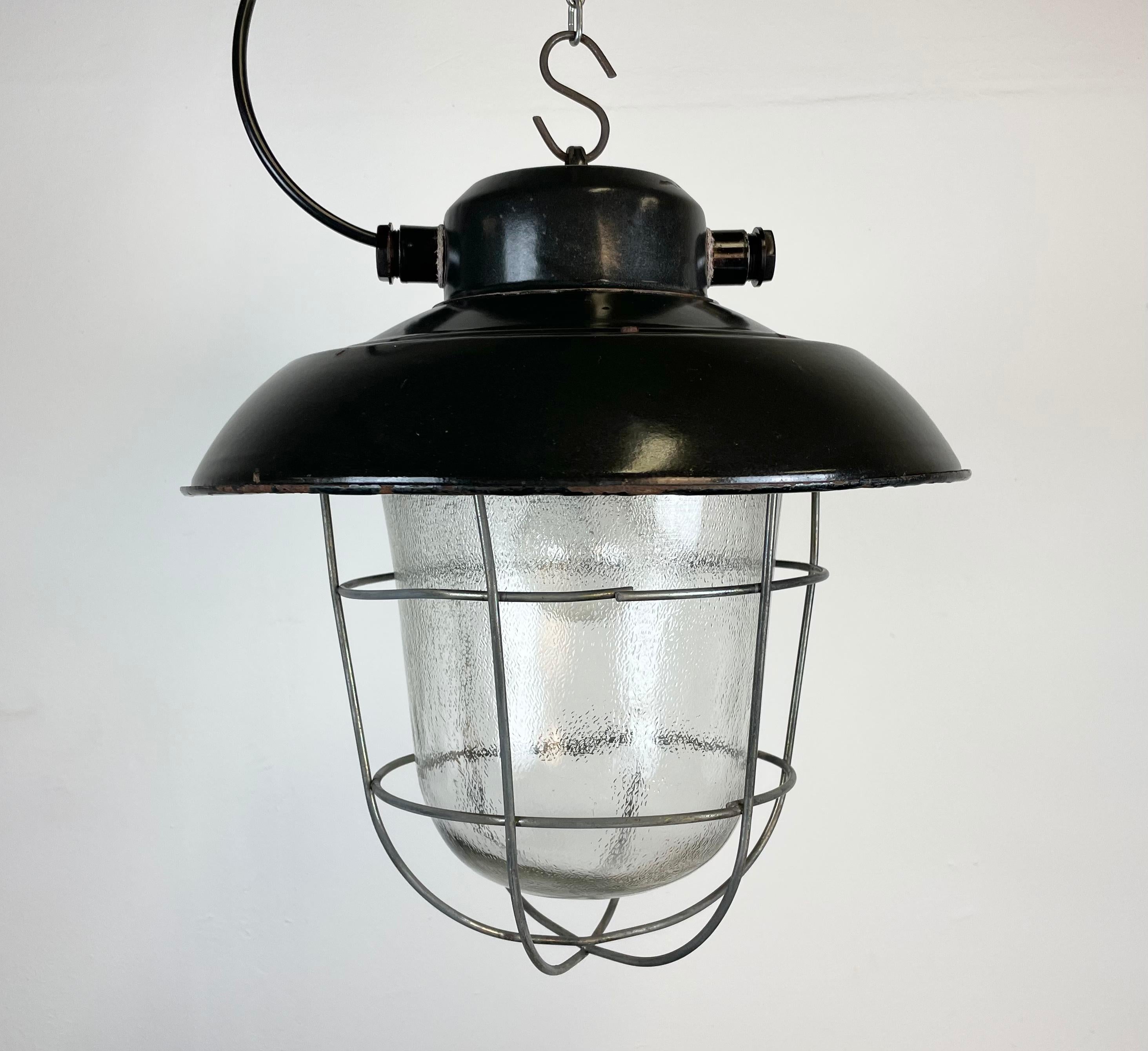 - Vintage industrial lamp made by Elektrosvit in former Czechoslovakia during the 1960s
- Black enamel shade with white interior.
- Frosted glass, Iron grid.
- Porcelain socket requires E 27 lightbulbs.
- New wire.
- Weight: 4 kg.
- Fully
