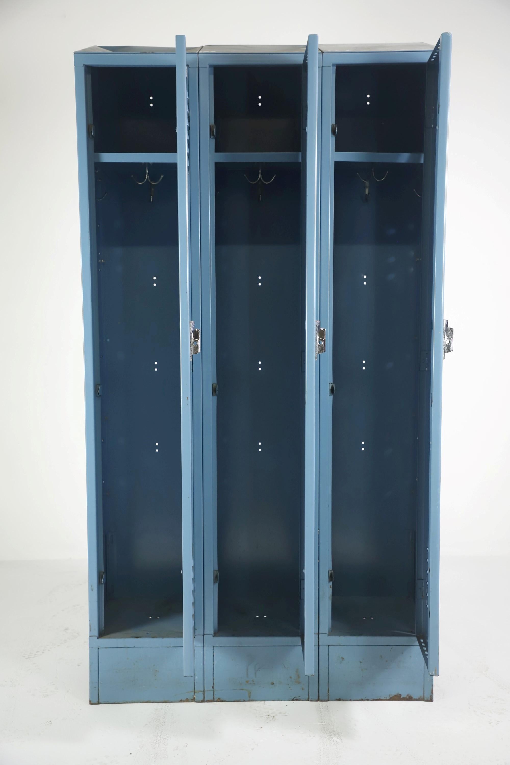 Industrial blue painted steel locker with three single tier doors interior hardware. They are numbered 