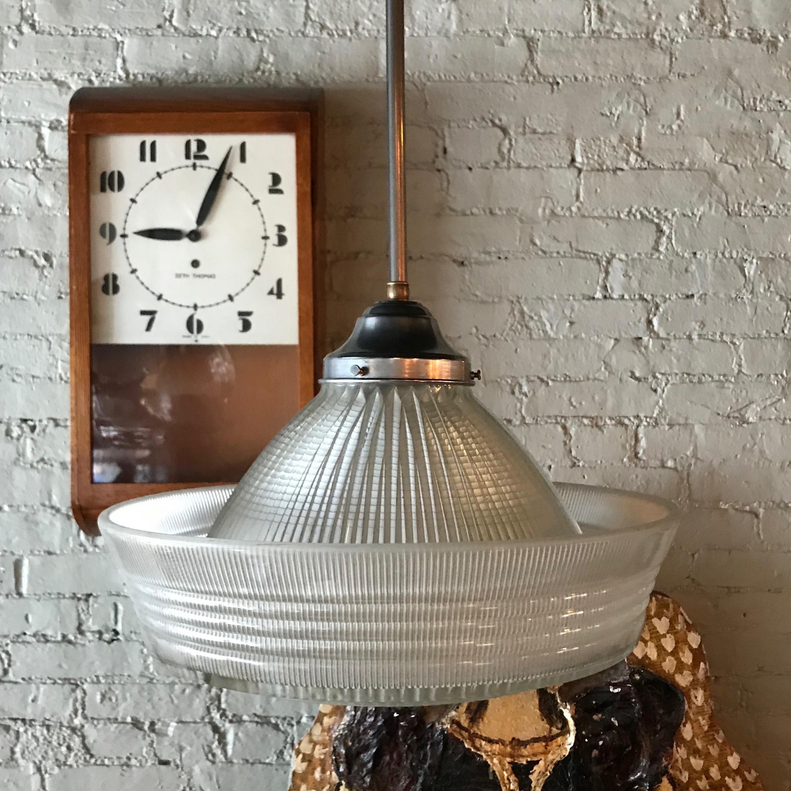 Monumental, rare, Holophane pendant light features three intricate, prismatic patterns on it's dome, side and bottom of brim with steel fitter and stem is newly wired to accept a 300 watt bulb. Measures: Height to top of fitter is 12 inches.