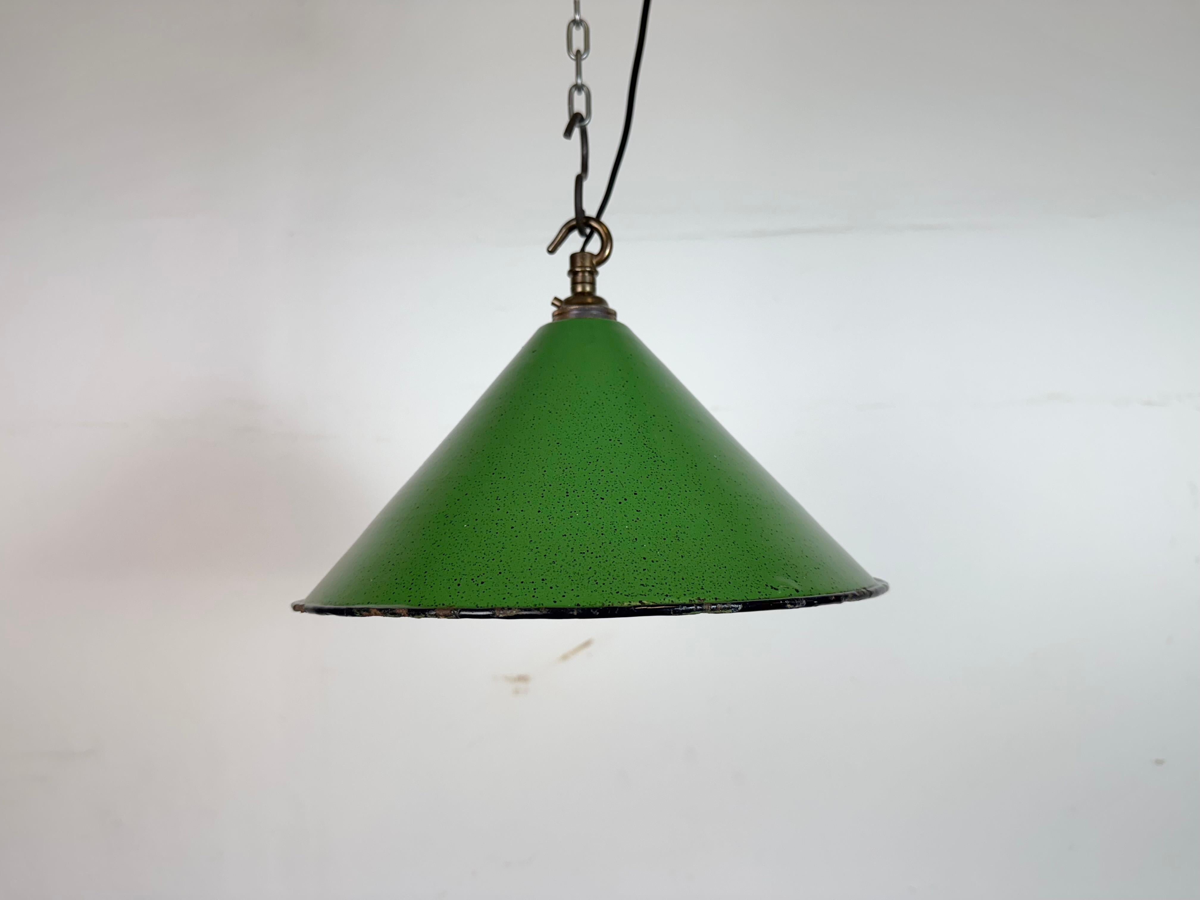 Industrial green enamel factory pendant light made in United Kingdom during the 1950s . White enamel inside the shade. Brass top. The socket requires bayonet B22 light bulbs. New wire. The weight of the lamp is 0,45 kg.The diameter of the shade is