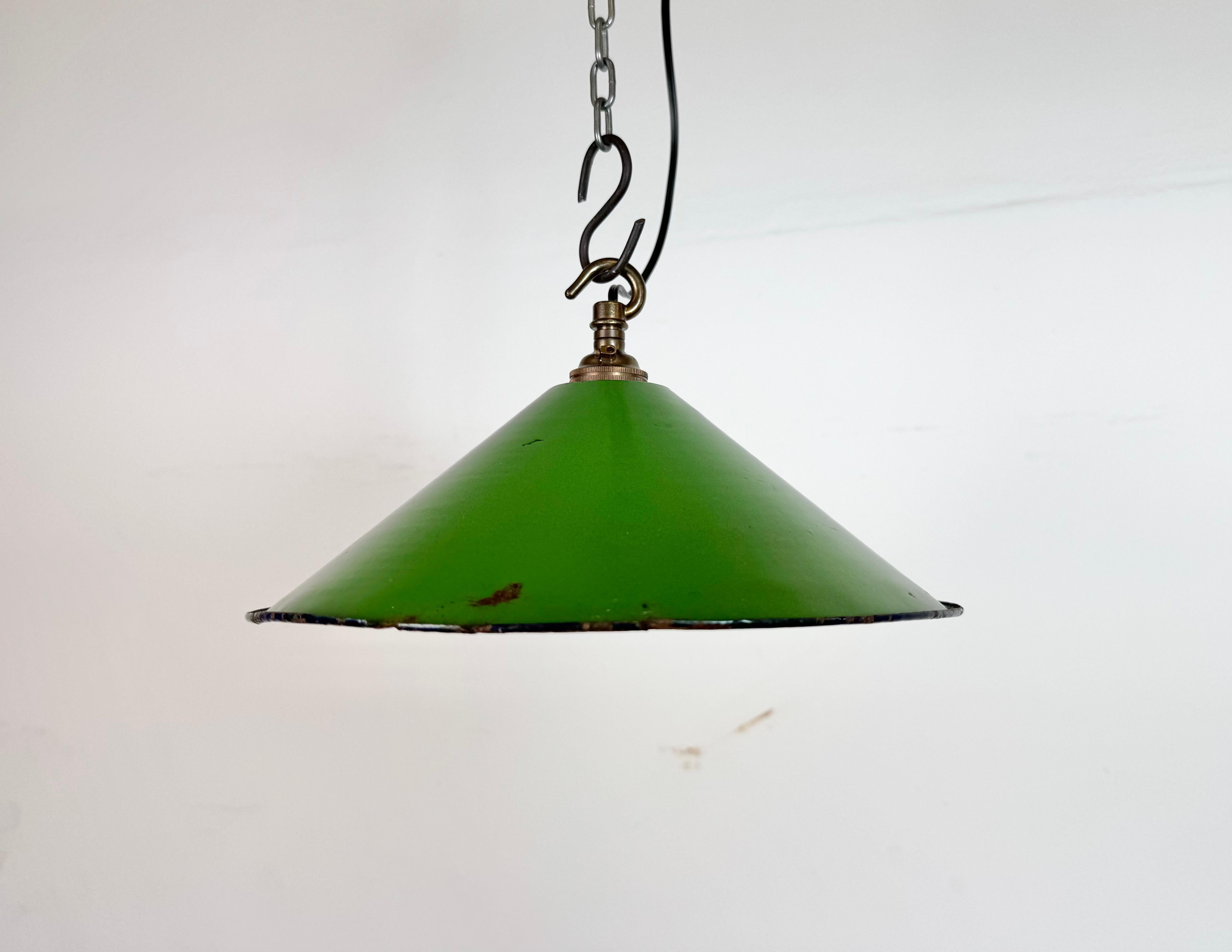 Industrial green enamel factory pendant light made in United Kingdom during the 1950s . White enamel inside the shade. Brass top. The socket requires bayonet B22 light bulbs. New wire. The weight of the lamp is 0,25 kg.The diameter of the shade is