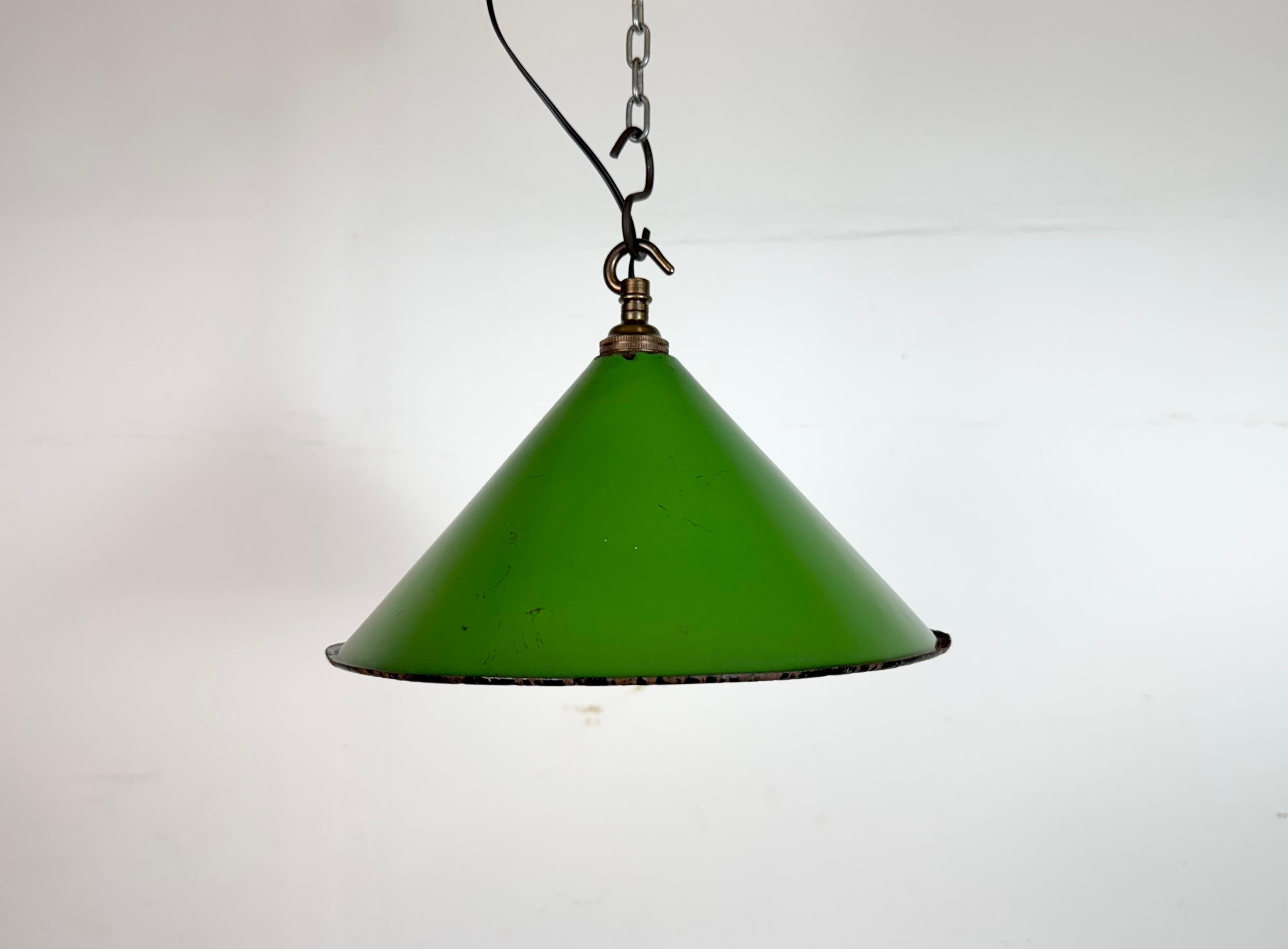 Industrial green enamel factory pendant light made in United Kingdom during the 1950s . White enamel inside the shade. Brass top. The socket requires bayonet B22 light bulbs. New wire. The weight of the lamp is 0,45 kg.The diameter of the shade is