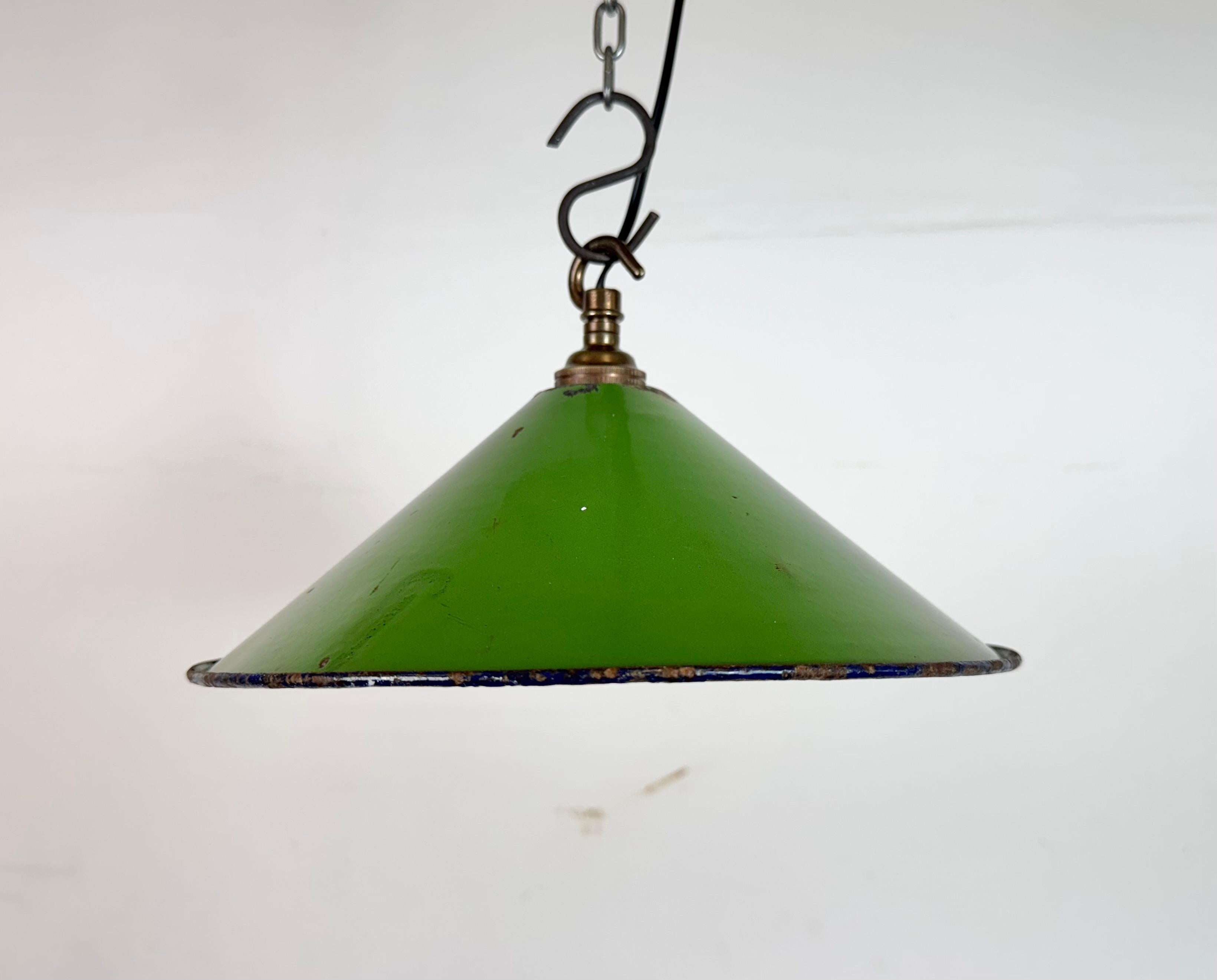 Industrial green enamel factory pendant light made in United Kingdom during the 1950s . White enamel inside the shade. Brass top. The socket requires bayonet B22 light bulbs. New wire. The weight of the lamp is 0,25 kg.The diameter of the shade is