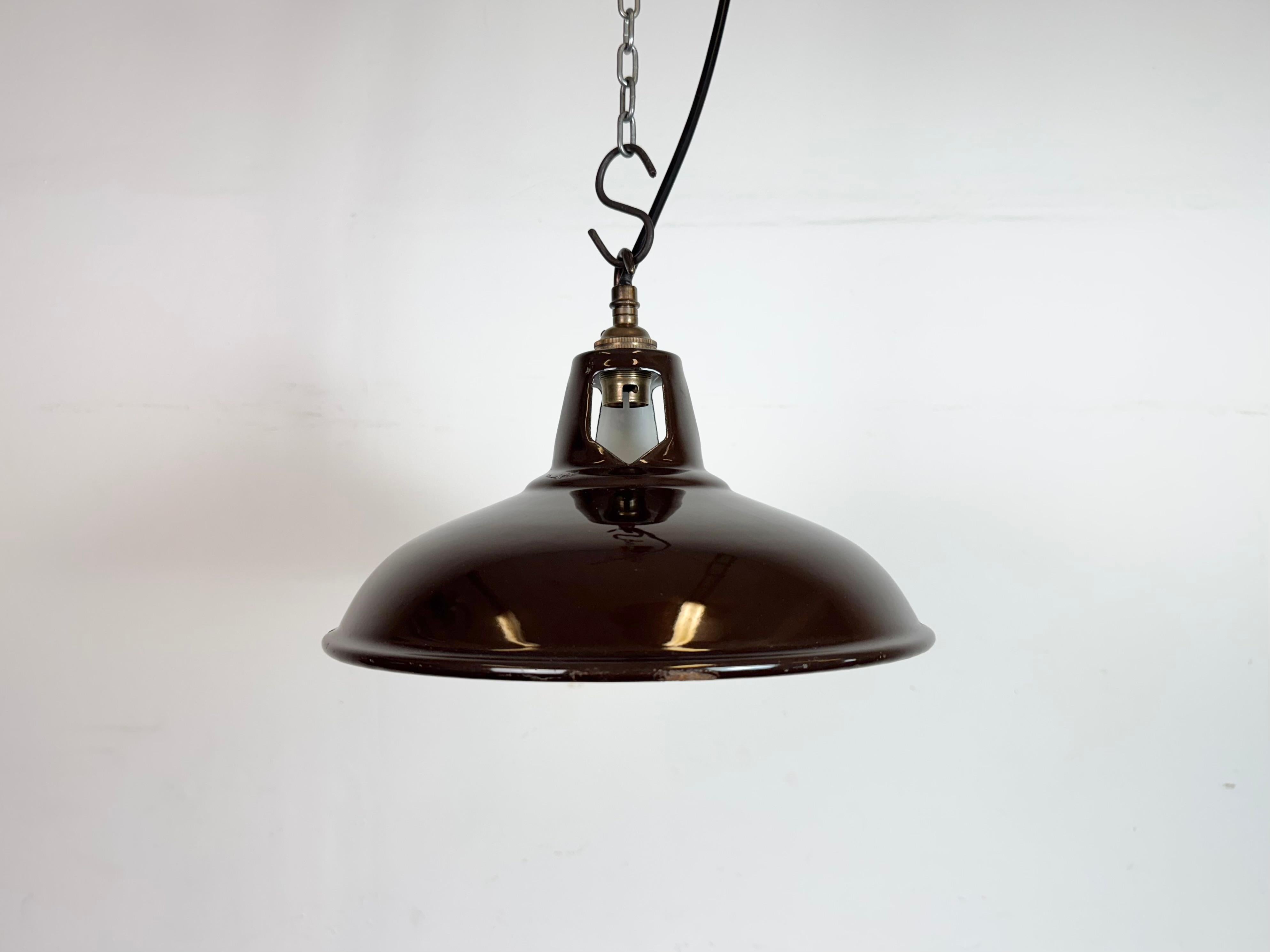 Industrial brown enamel factory pendant light made in United Kingdom during the 1960s. White enamel inside the shade. Brass top. The socket requires B22 light bulbs. New wire. The weight of the lamp is 0,6 kg.The diameter of the shade is 28 cm.