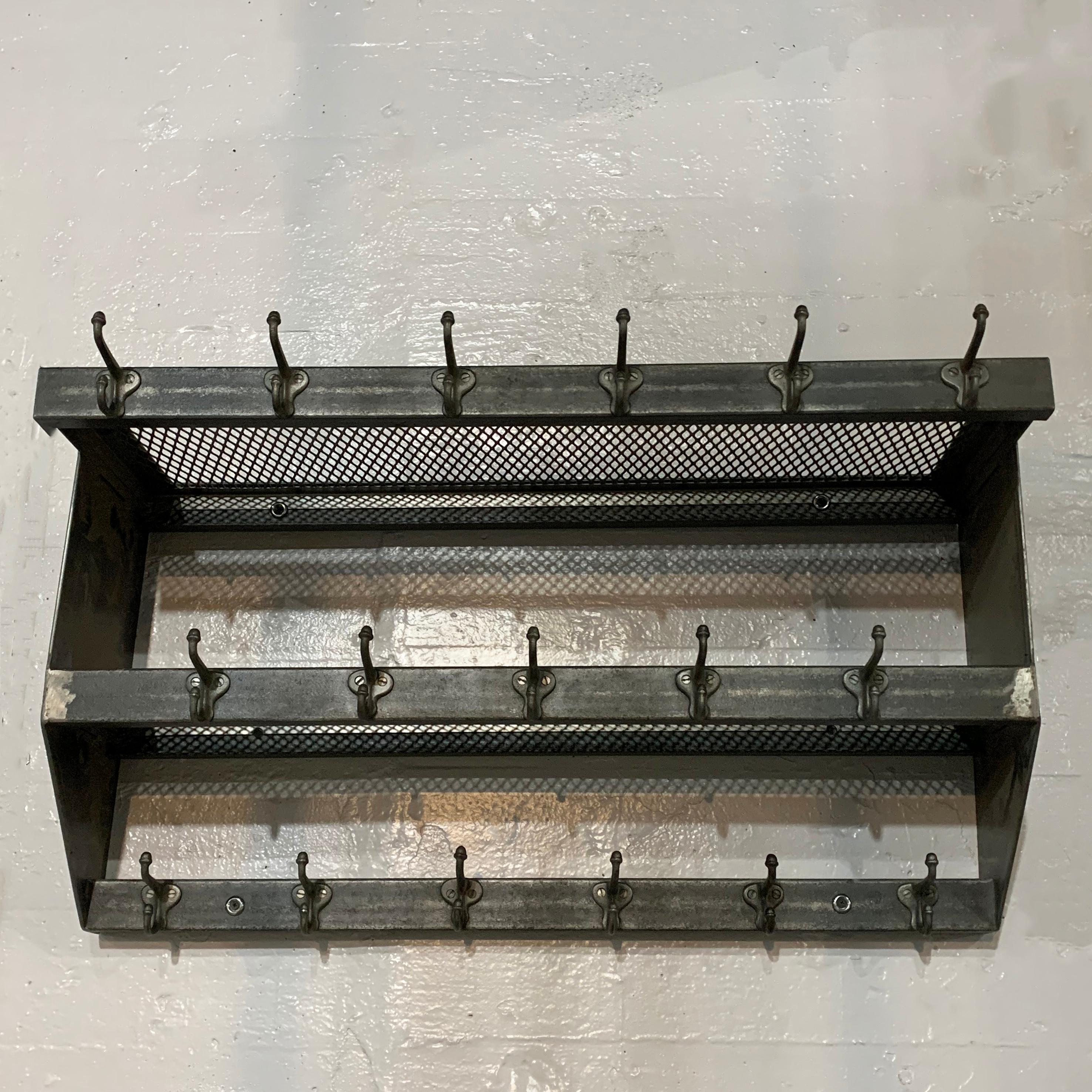 Industrial, brushed steel, wall-mount, school gymnasium, shelf unit features two, graduated, steel mesh shelves and 17 hooks for hanging. More are available if quantities are needed.
  