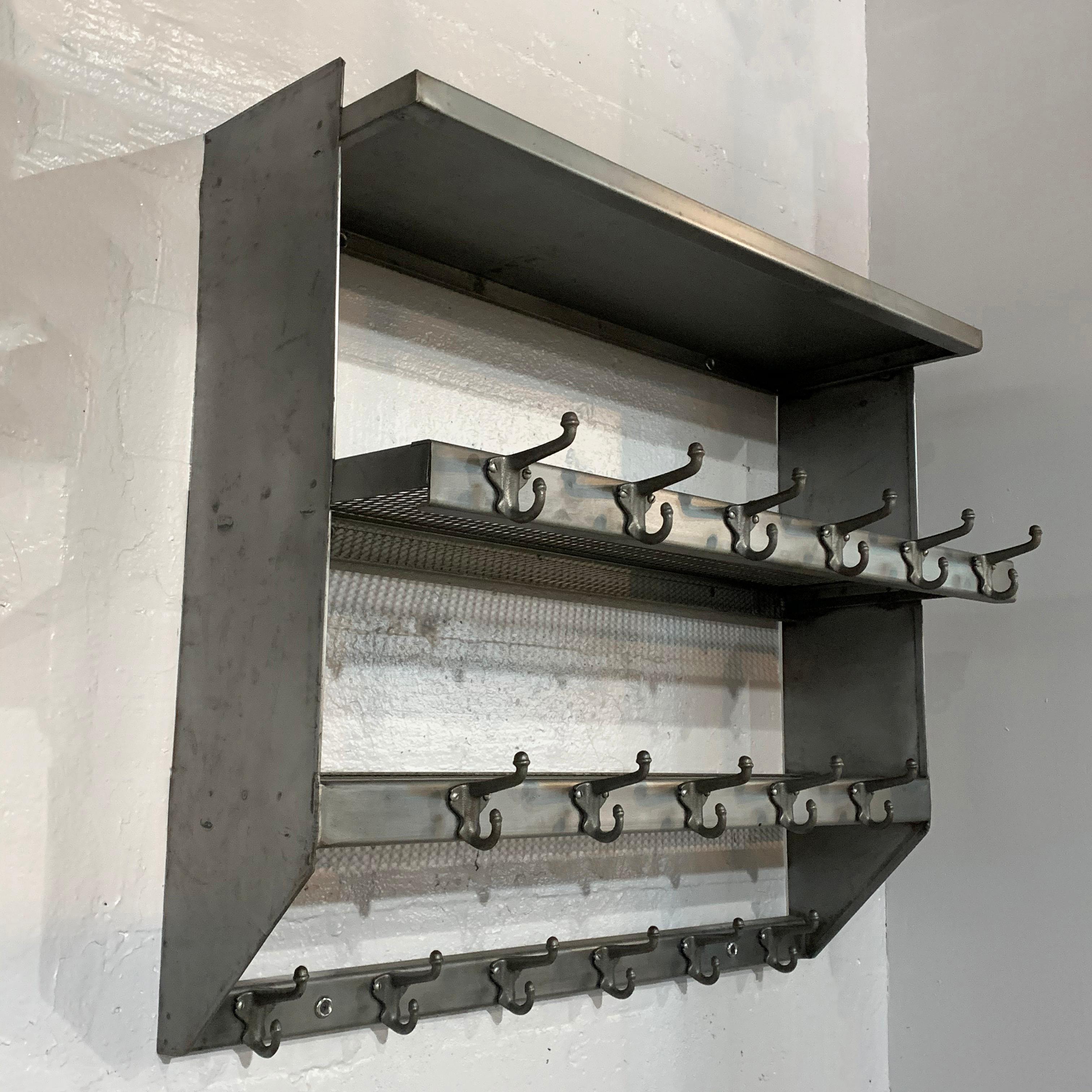 Industrial, brushed steel, wall-mount, school gymnasium, shelf unit features three graduated shelves; two of steel mesh and one solid steel on top and 17 hooks for hanging. More are available if quantities are needed.