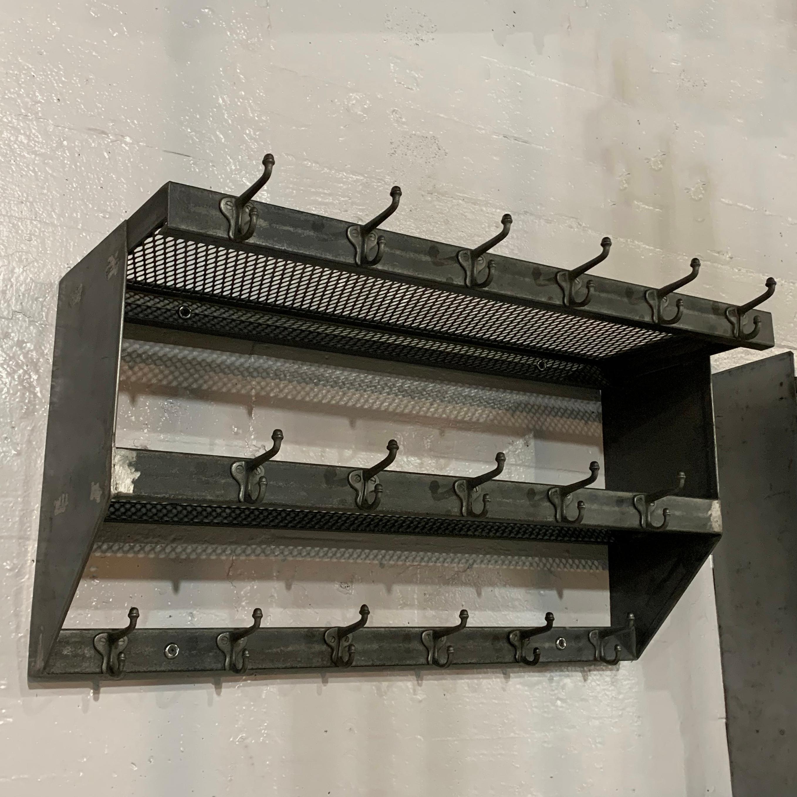 Industrial, brushed steel, wall-mount, school gymnasium, shelf unit features two, graduated, steel mesh shelves and 17 hooks for hanging. More are available if quantities are needed.
 
