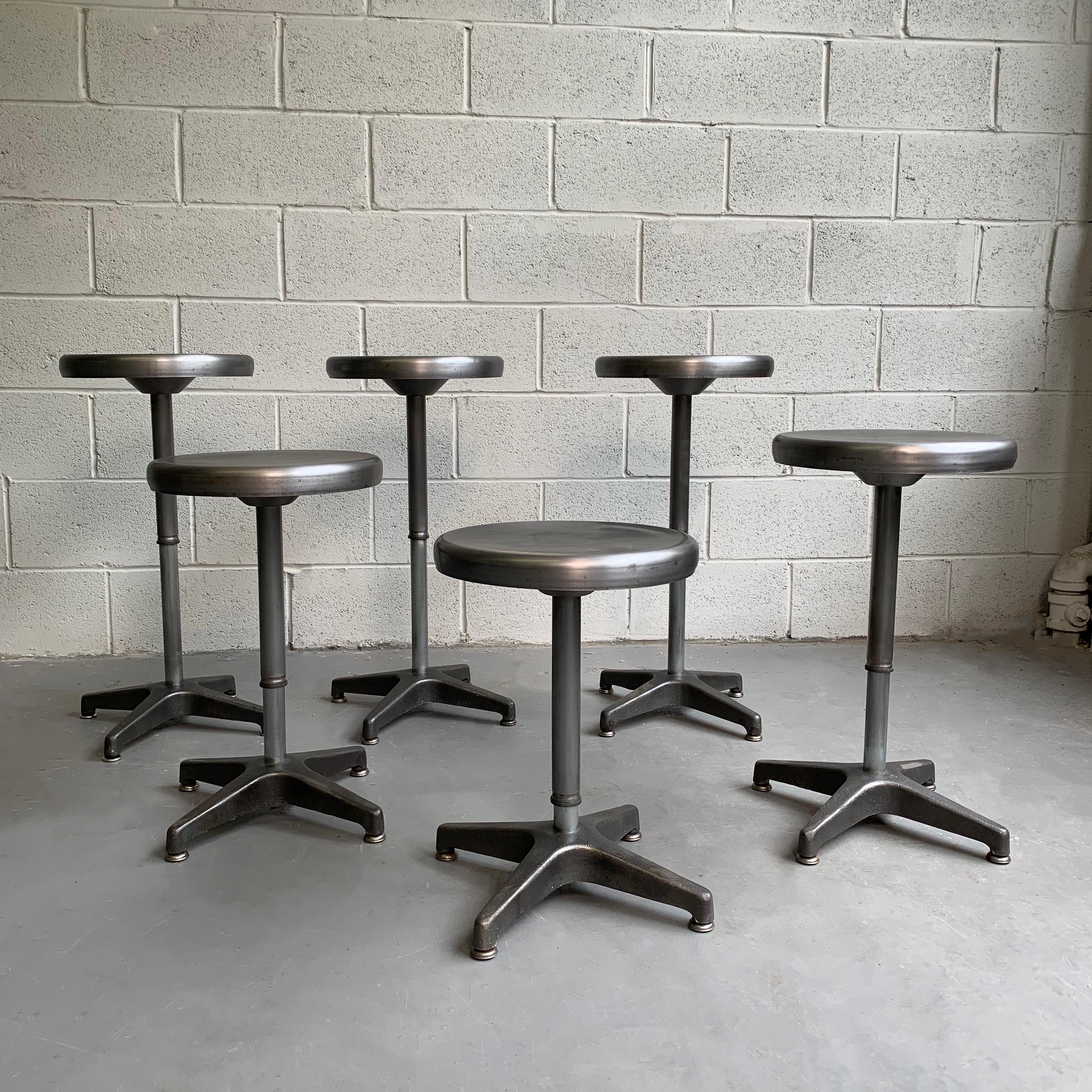 Industrial, brushed steel, swivel stools are incrementally height adjustable from dining height 18 inches to counter height 27 inches. The seat diameter is 13 inches and the foot print is 16 inches diameter. Sold individually.