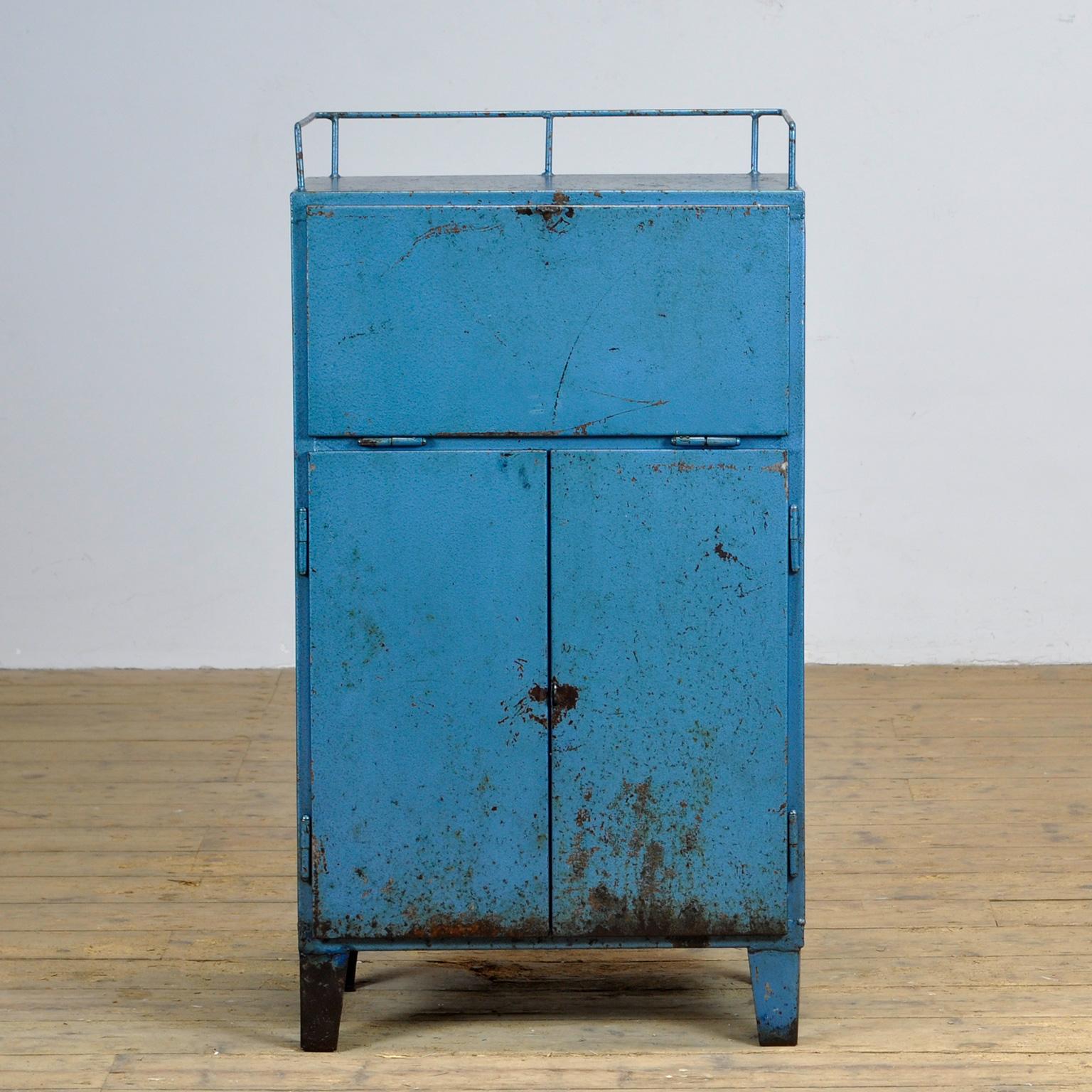 Industrial cabinet from the 1970s, made of iron. With four drawers and a shelf on the inside. A flap at the top. Treated against rust and finished with clear lacquer.