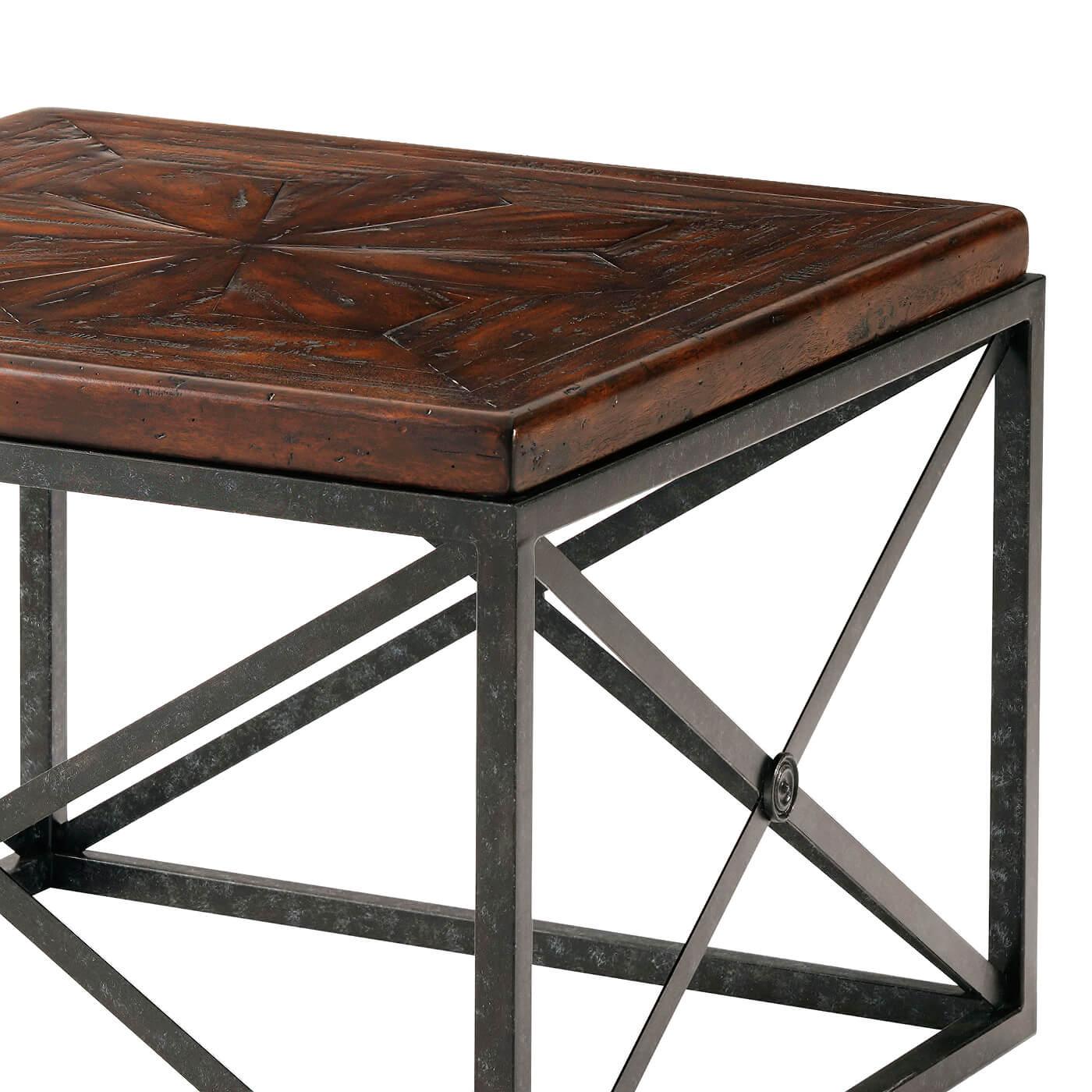 Industrial Campaign cocktail table an antiqued wood, brass and iron Campaign bunching cocktail table, the square stellar parquetry top on square verdigris legs joined by 'X' sides.

Dimensions: 28.5