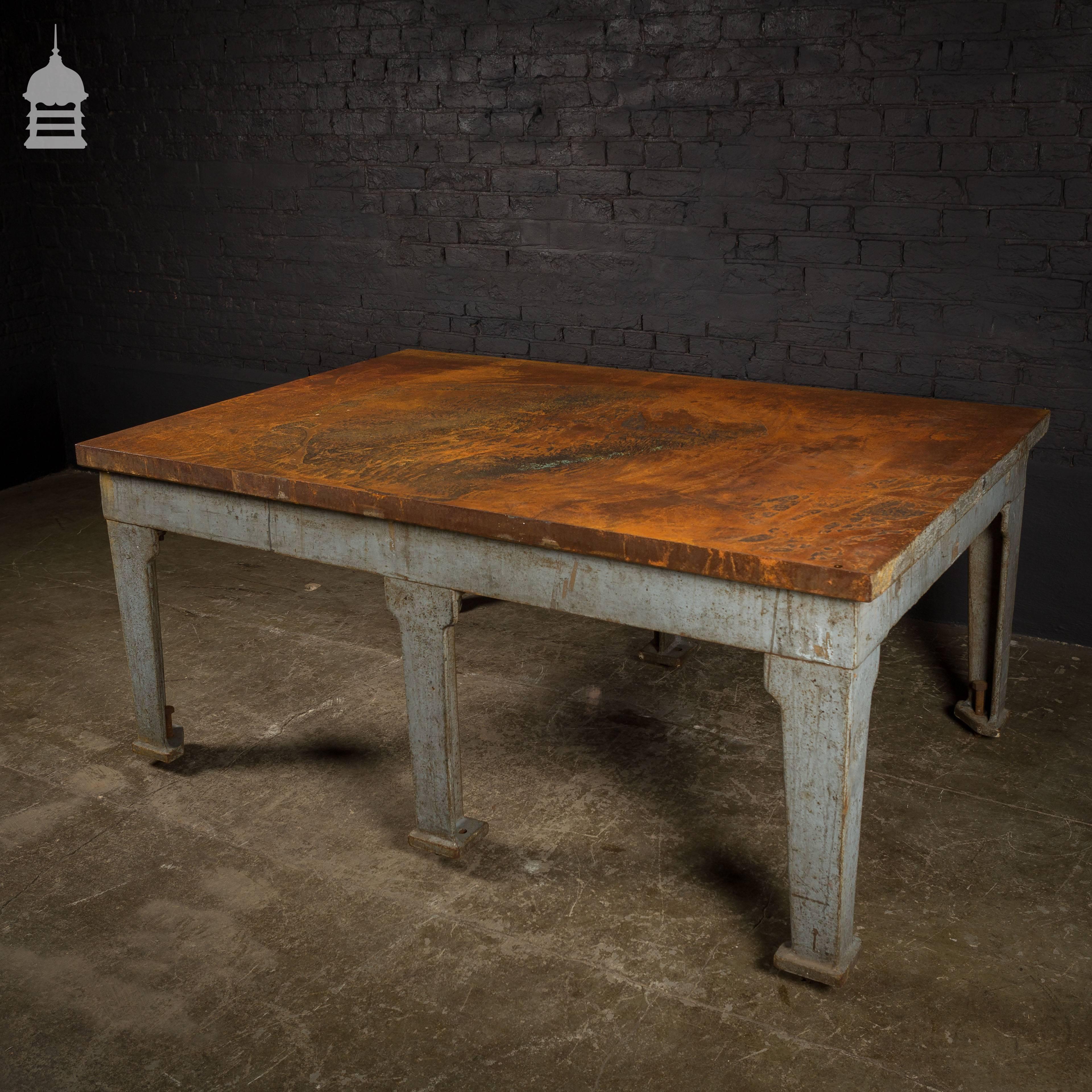 Industrial cast iron surface table with six legs.