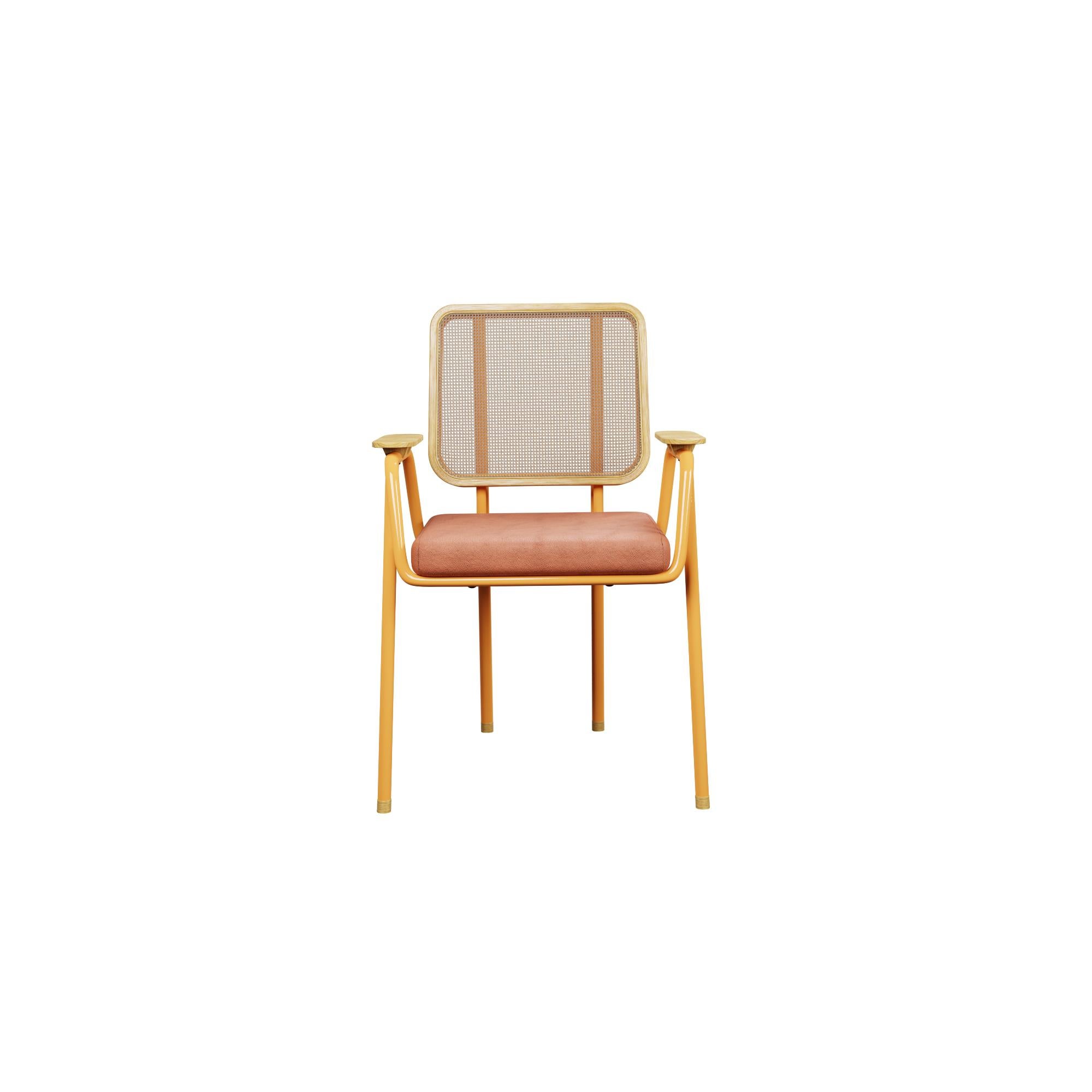 Murmurio's chair with arm DUV sturdy iron structure provides a solid foundation, while the intricately woven rattan backrest, supported by an ashwood frame, adds a touch of natural beauty. The seat is upholstered in genuine leather, offering both