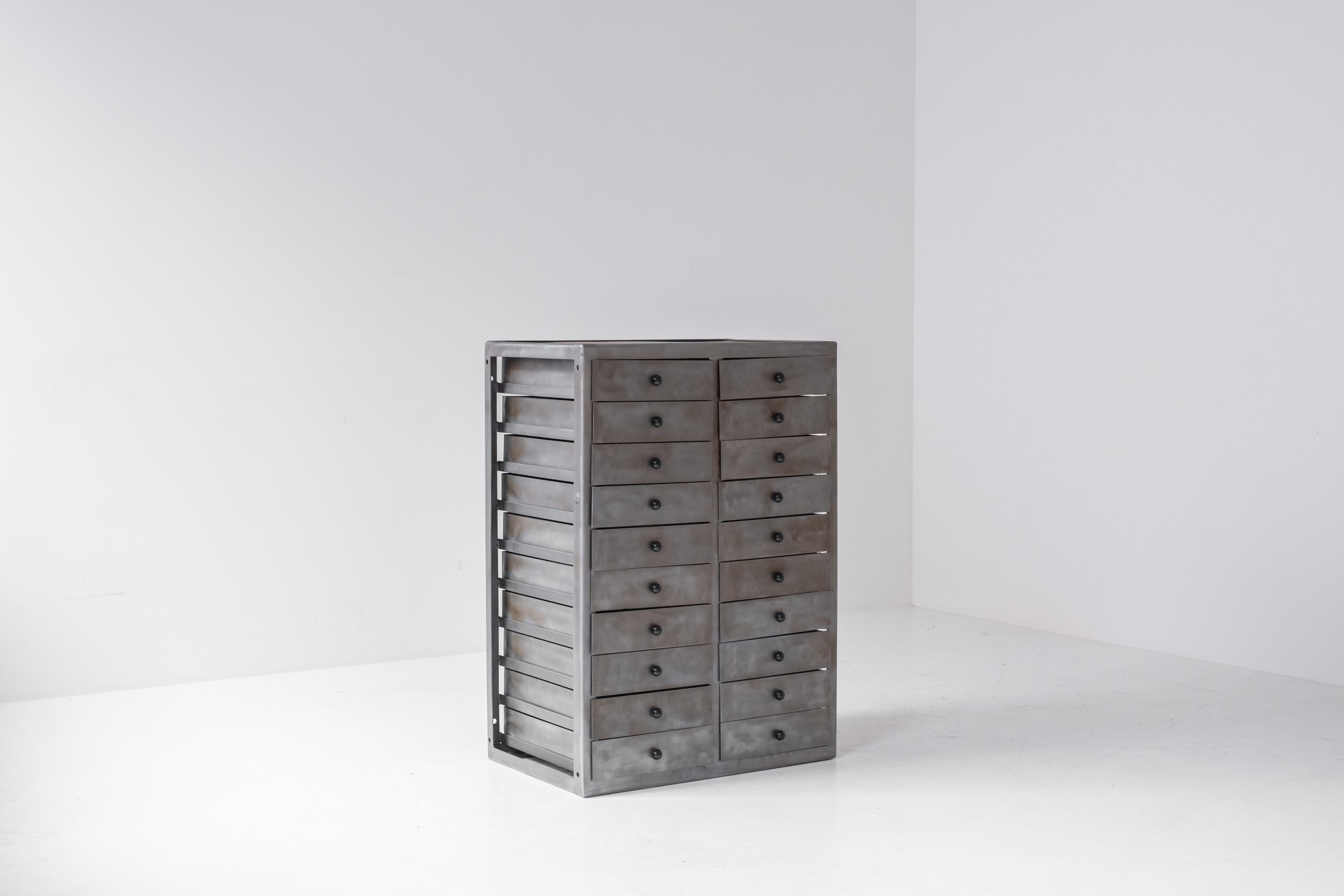 Industrial chest of drawers designed in the Netherlands around the 1960s. This cabinet is made out of steel and features two series of each 10 drawers. The open frame gives the cabinet an extra dimension and makes it playful at the same time.