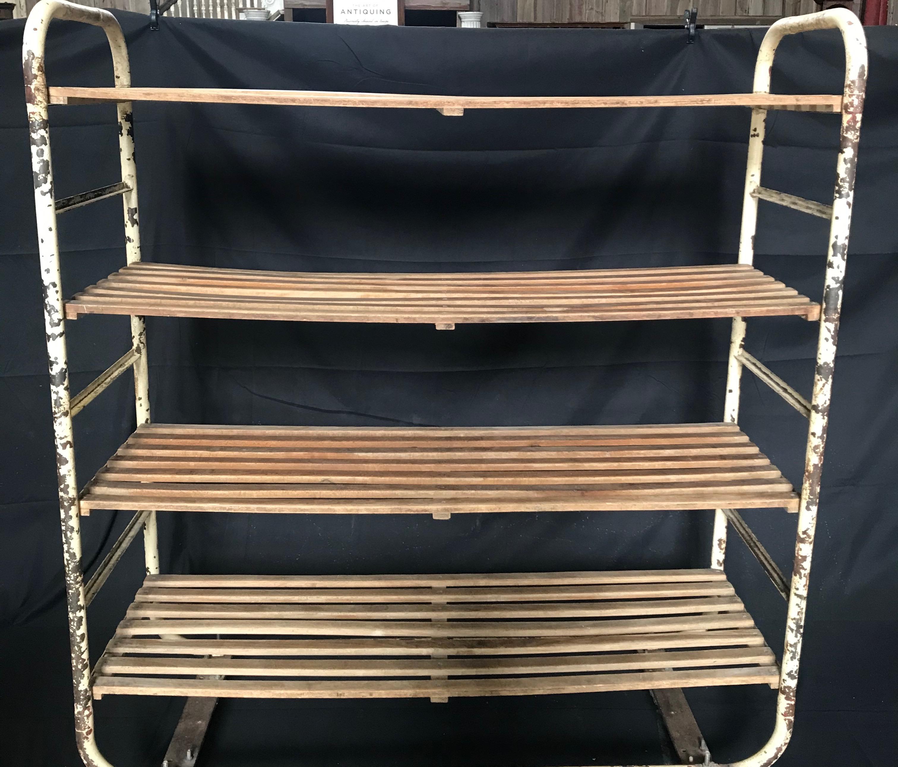 Very unusual antique French metal bakers rack having four wooden shelves and fully functional casters. Multi purpose storage for a kitchen, dining serving room or loft. Also a fabulous shop display!


Measures: H between shelves 15”.