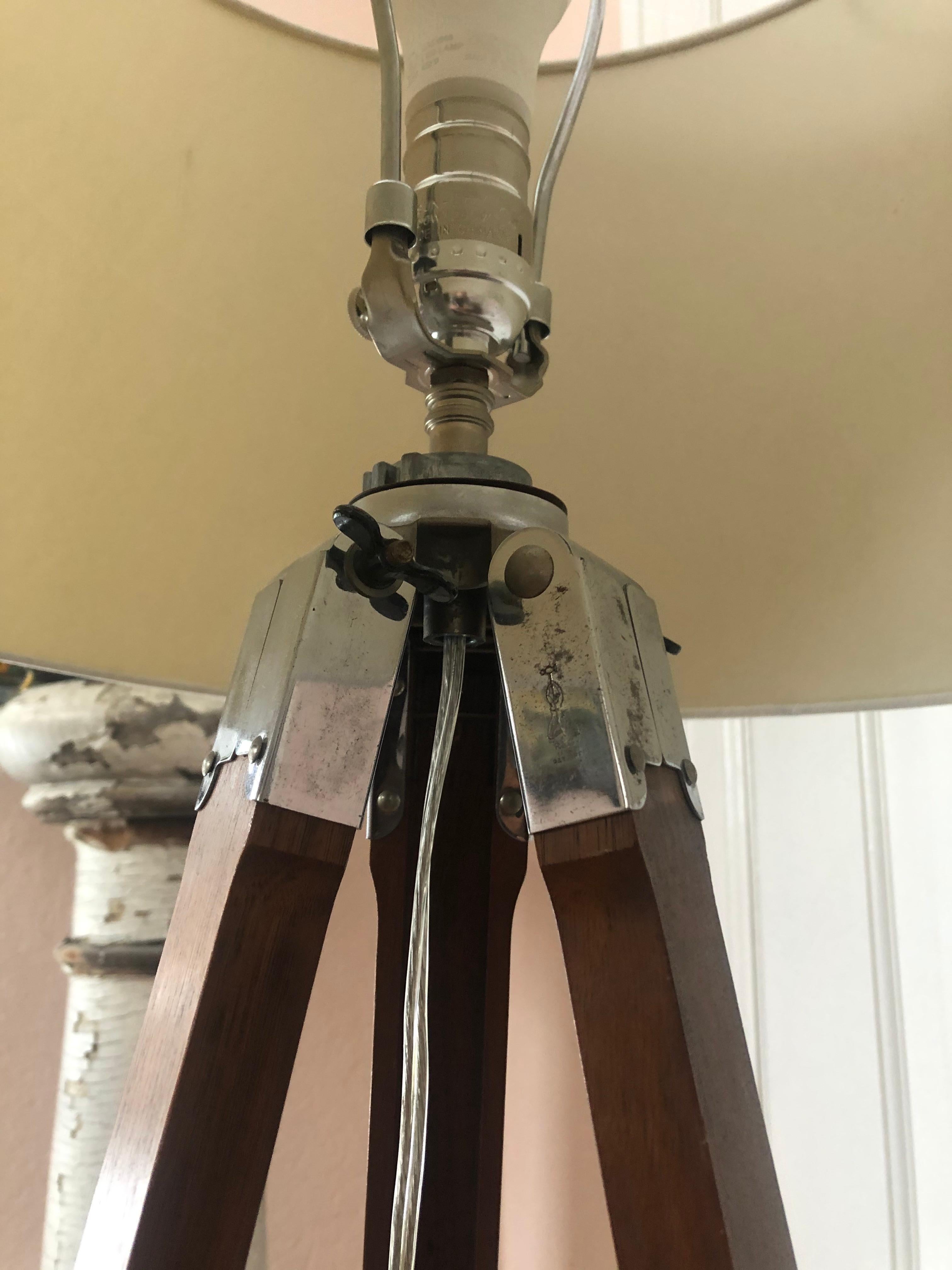 A handsome wood and chrome tripod surveyors stand made into a Classic floor lamp.