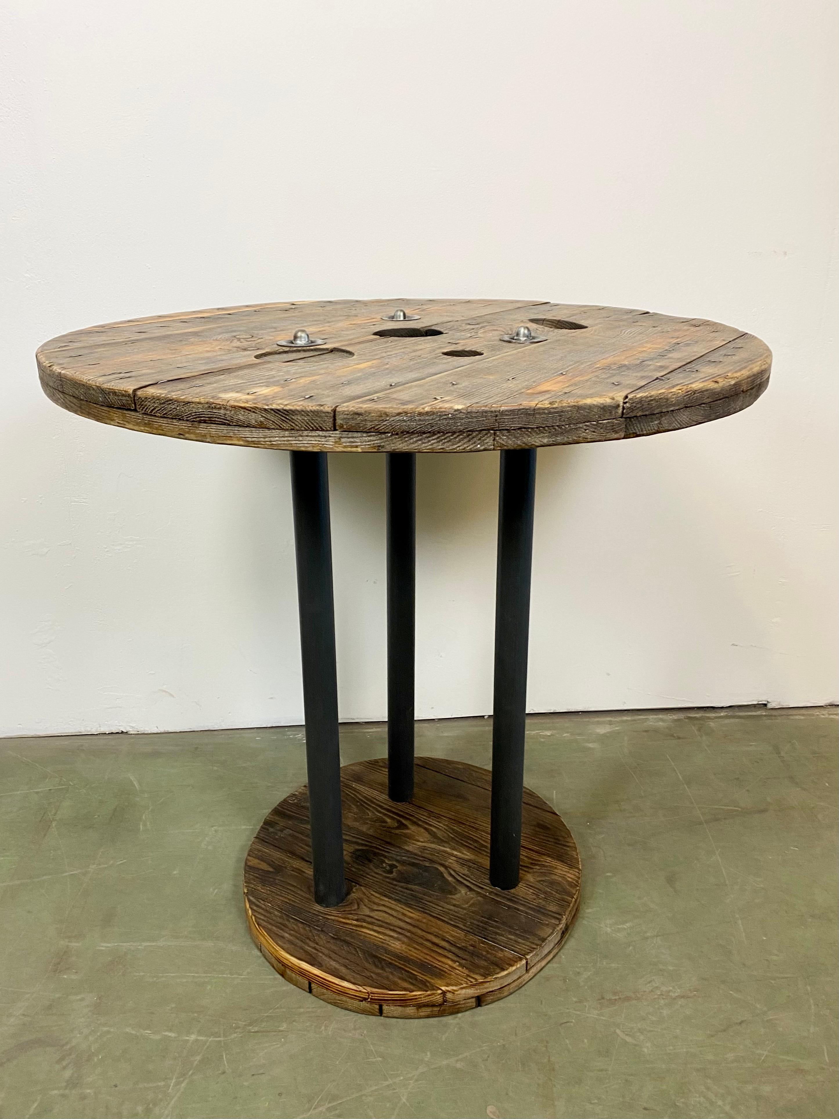 Vintage Industrial circle coffee table from the 1960s. It features black iron legs and a solid wooden plates with very nice patina. Weight: 24 kg.
Additional information:
Diameter of the plates: Upper 80 cm, bottom 50cm
The price for transport is