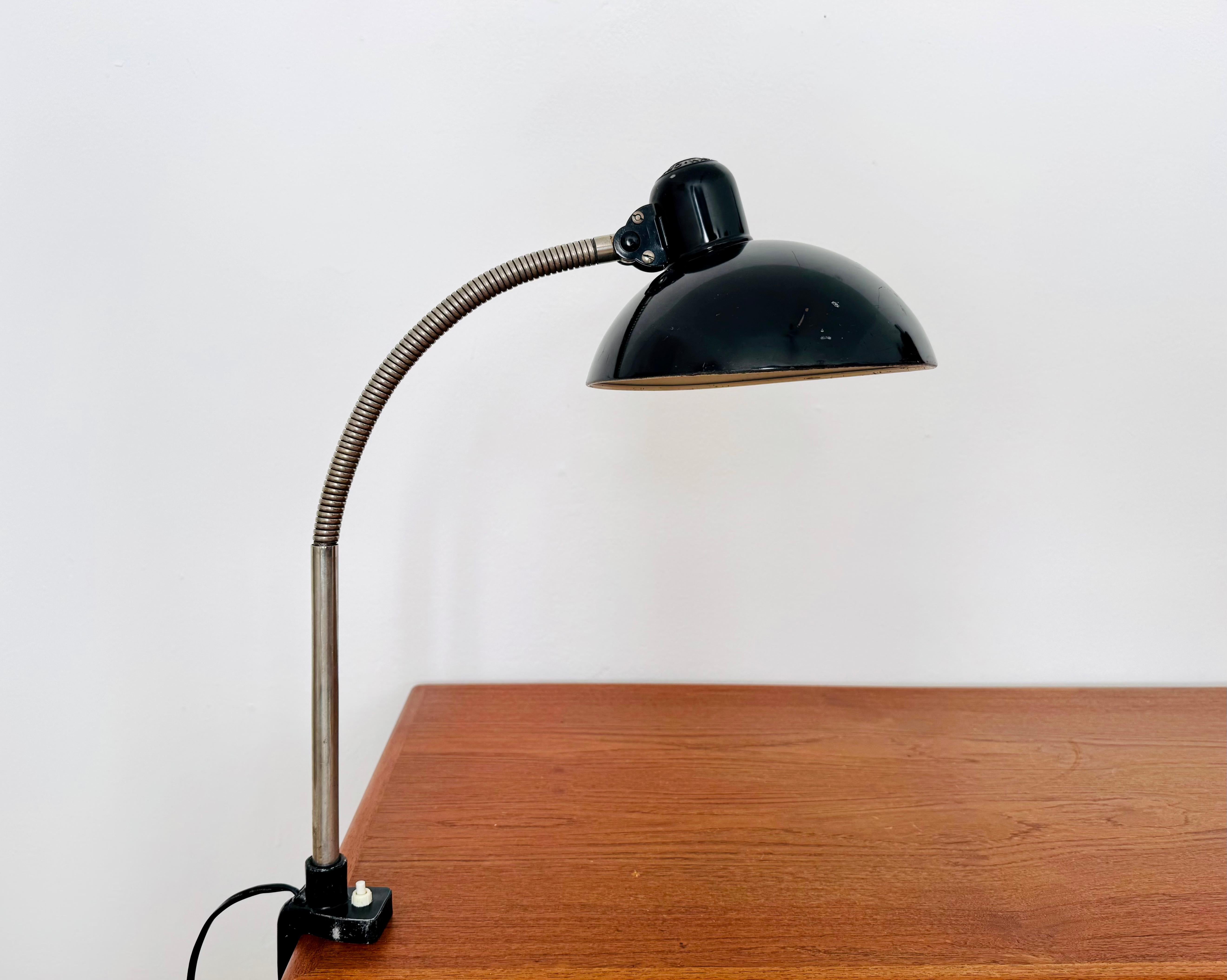 Wonderful clamp lamp from the 1930s by Kaiser Idell.
Fantastic design and an absolute classic.
The combination of high-quality craftsmanship and meticulous details is an asset to any home.
The gooseneck allows for flexible adjustment of the