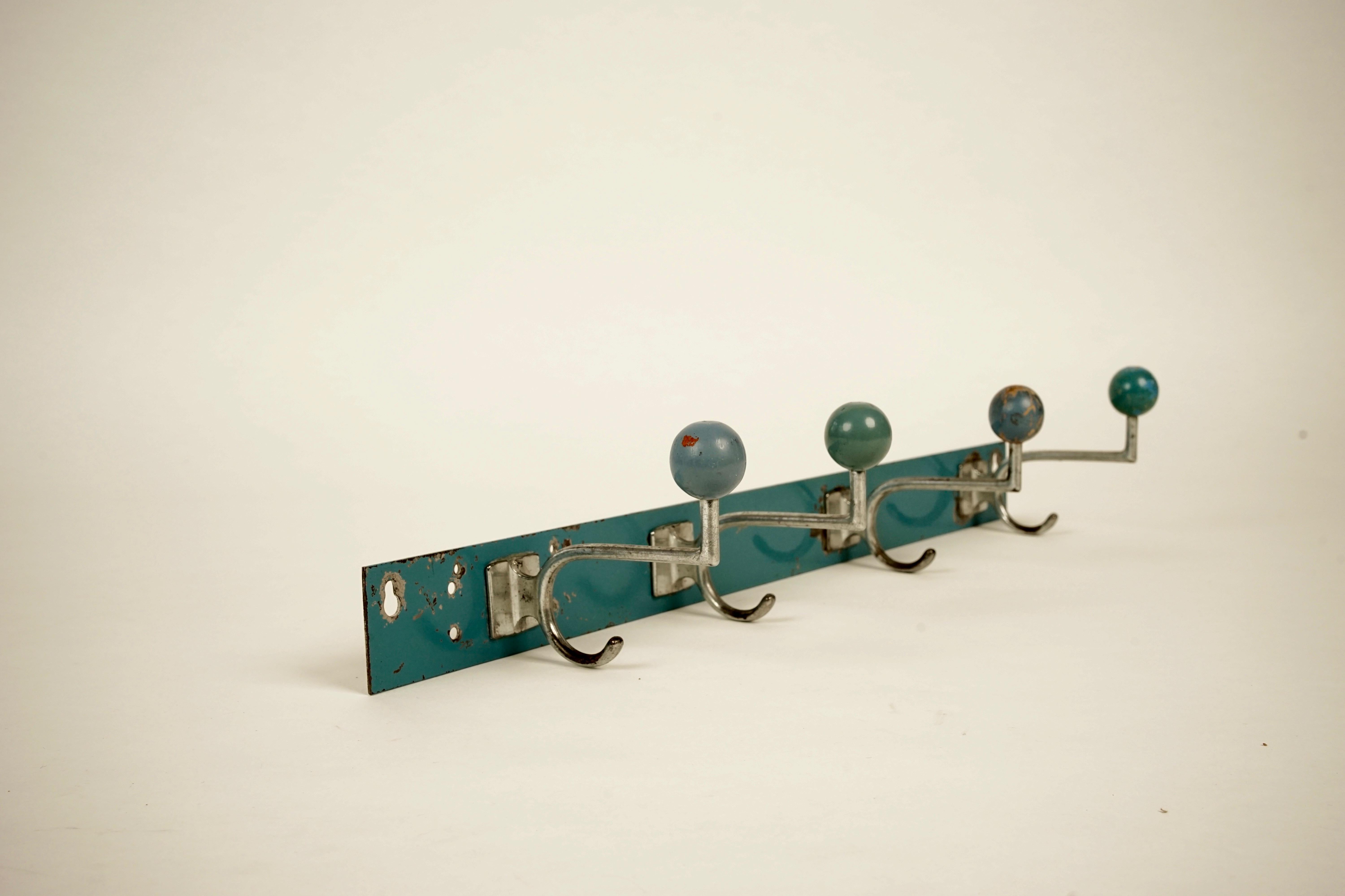 Coat hooks from the 1930s.
Wonderful industrial design, manufactured in metal, chrome platted with wooden knobs, painted in turquoise blue.