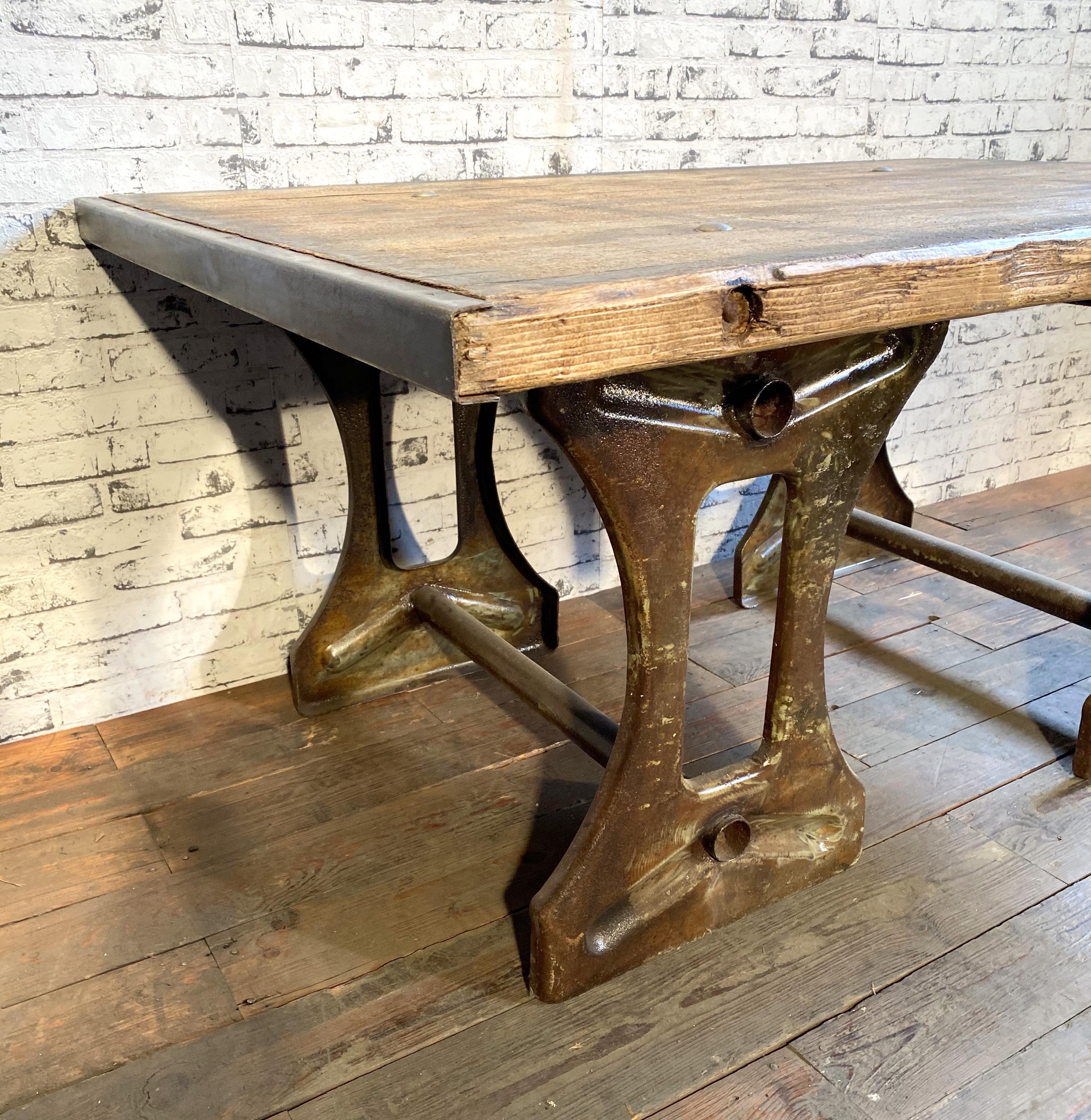 Vintage industrial coffee table from the 1950s. It features iron construction and a solid old wooden plate with very nice patina. Weight: 60 kg.