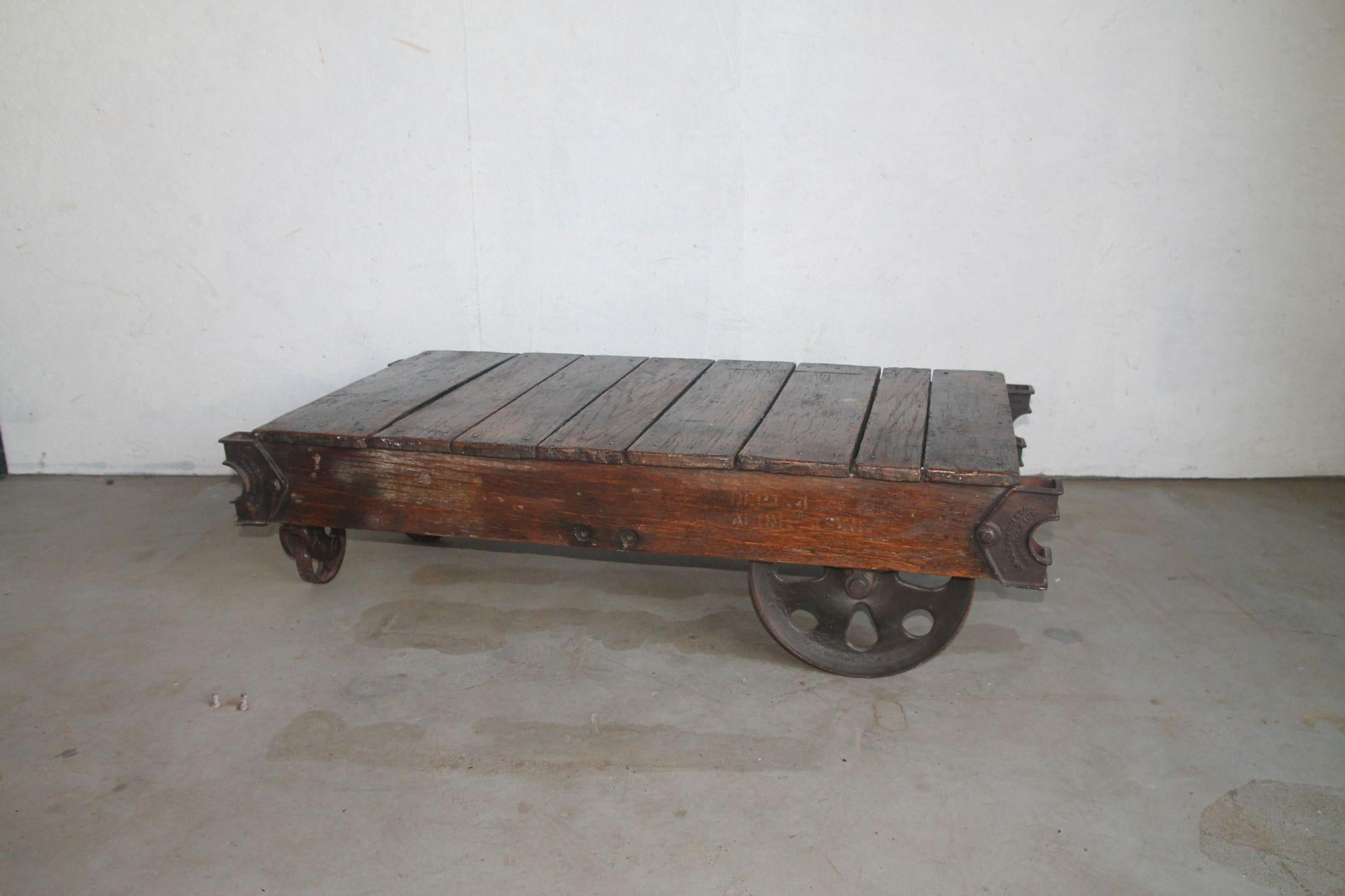 Pleased to offer this great orginal industrial coffee table cart. This amazing cart has 4 iron wheels. This will look great in any decor. This was just removed from a NYC loft.