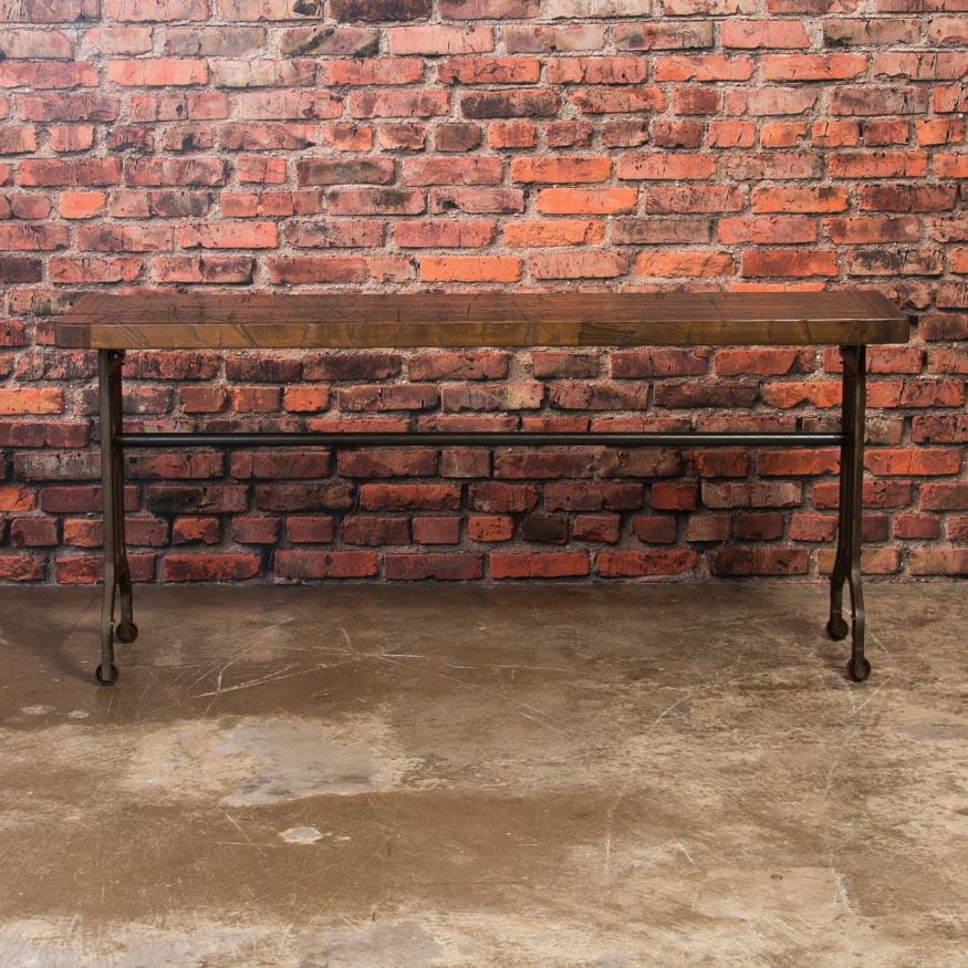 This console table has a strong aesthetic appeal due to the combination of the rich, maple top and the aged, Industrial legs. The table is made in the USA from reclaimed maple railroad box car flooring that show years of use and wear while the cast