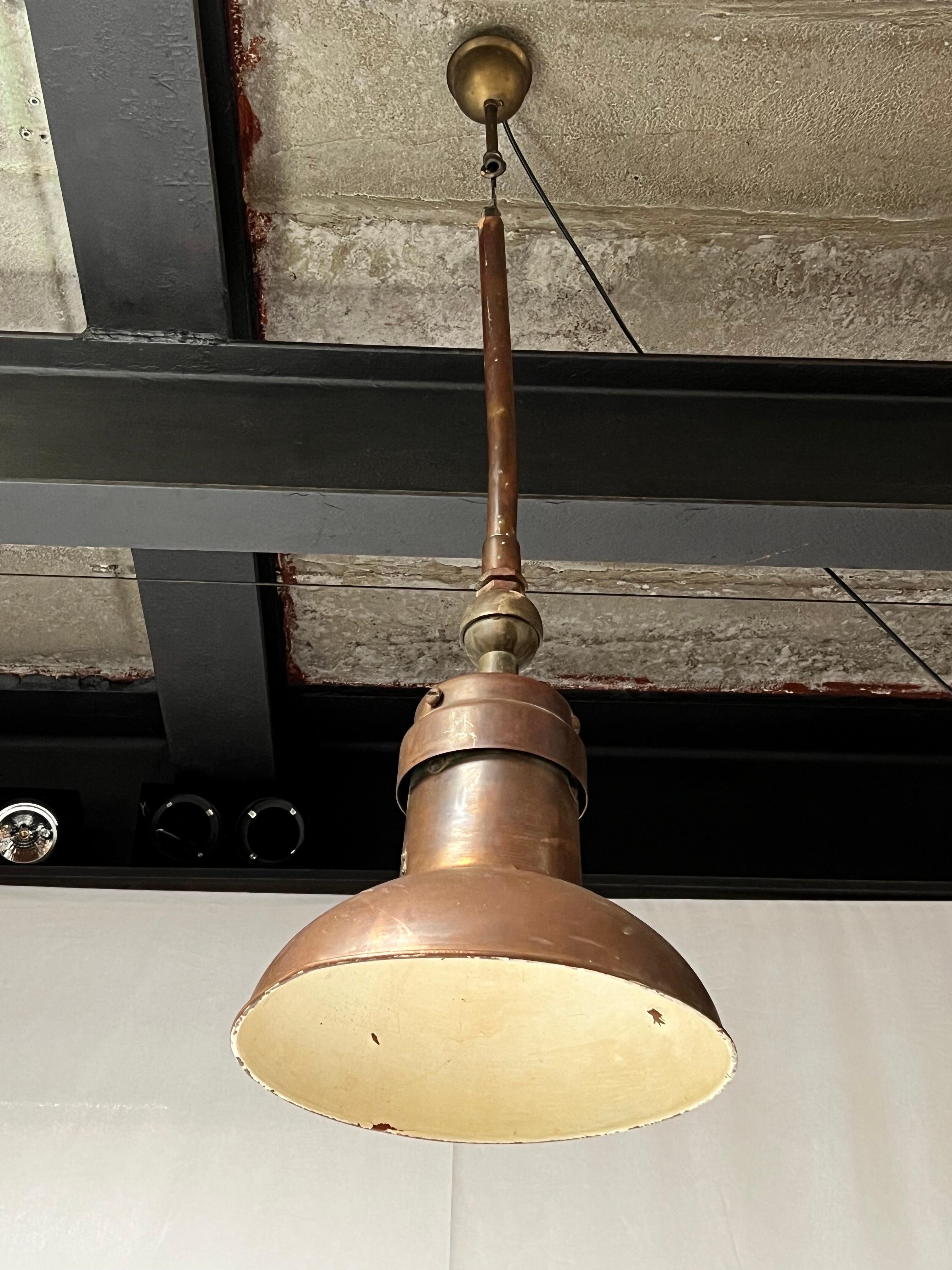 Delicate but strong copper and brass suspension lamp made in the 1850s in England. The lamp is well patinated and shows traces of time and use. Some minor pealing paint in the inside. The brass parts are also patinated. Fully functioning.