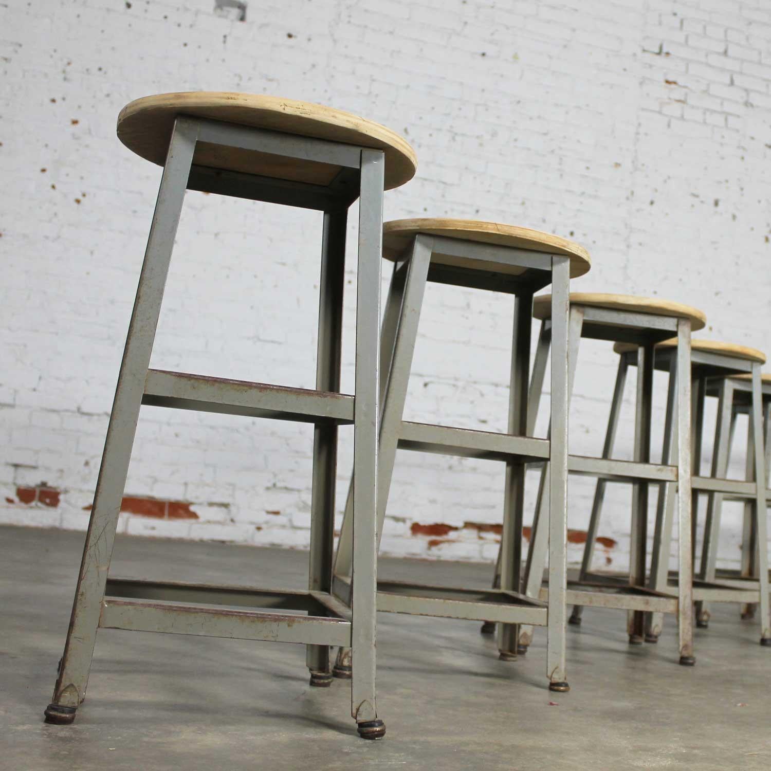 Vintage industrial counter height steel stools with fabulous patinated finish that only comes with age. In wonderful condition. The wood tops have been sanded and are ready to be oiled, clear coated, painted, or left natural to let age, circa