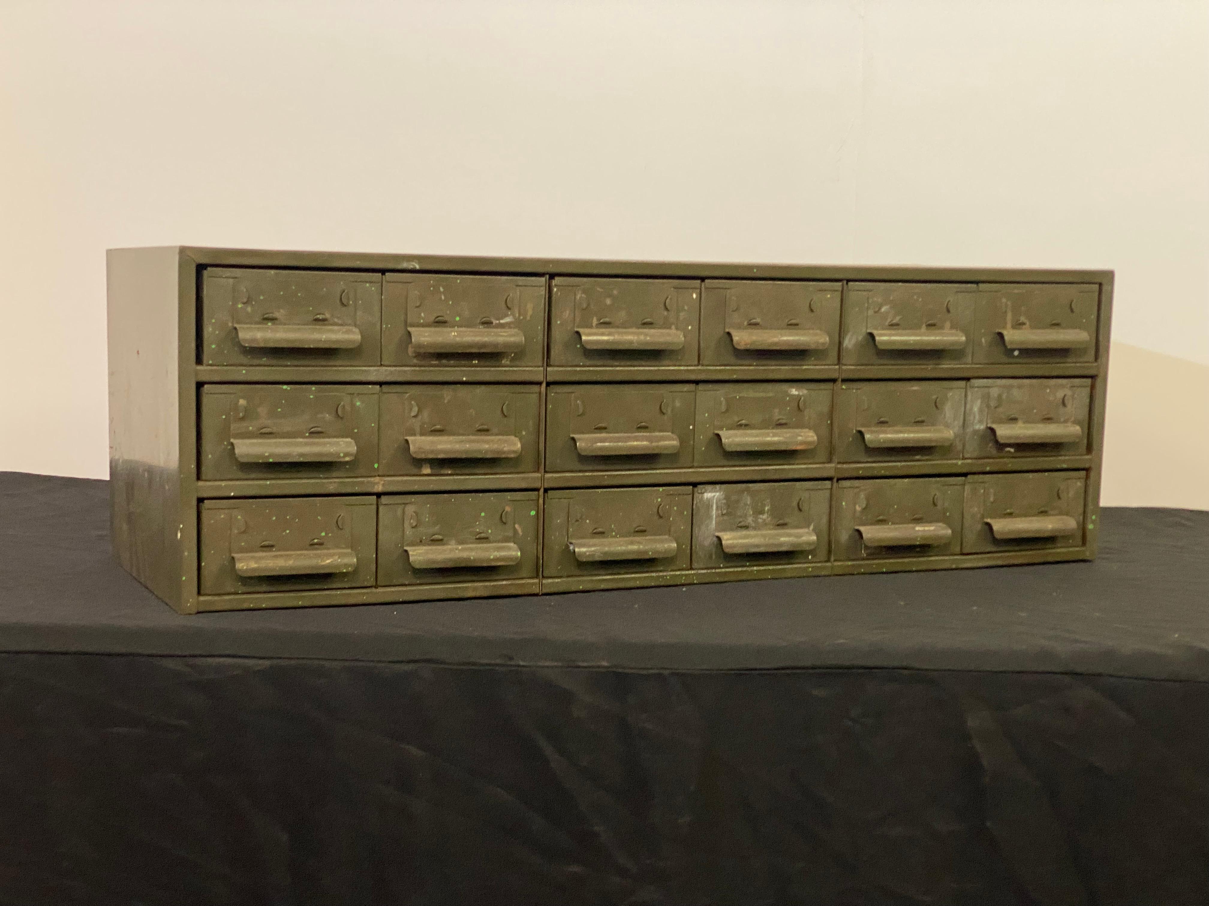Straight out of the mechanic's shop in Verplanck, NY. A durable eighteen drawer parts and hardware cabinet. A fantastic heavy duty organizer that would fit nicely on any work bench or table. Curved handles and raised tab holders for easy