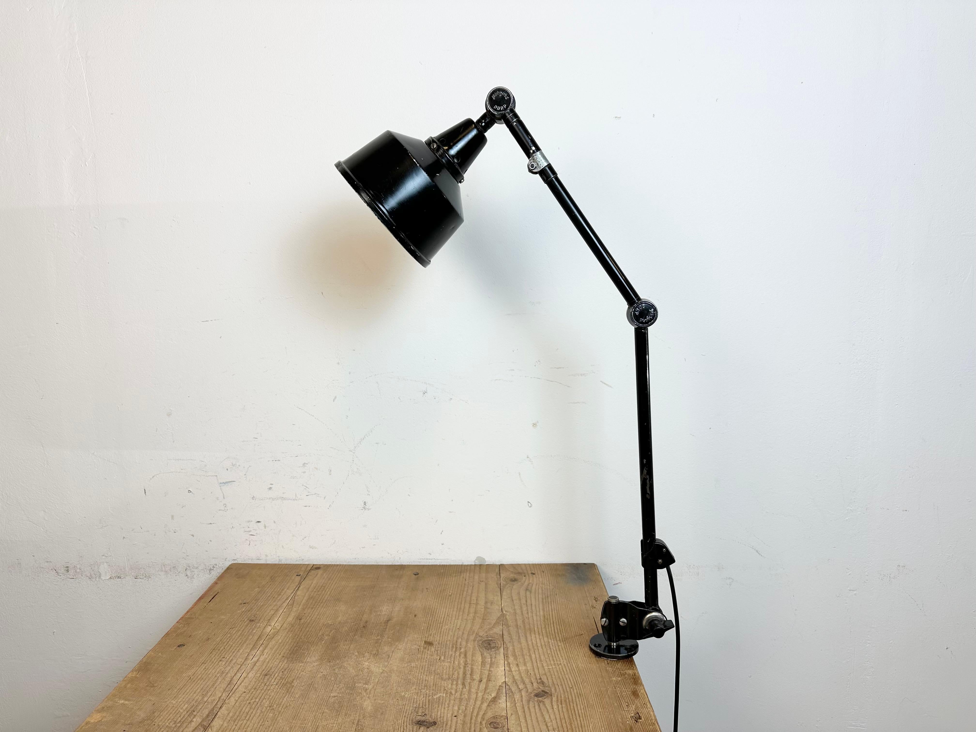 - Industrial workshop table lamp produced by Midgard in Germany during the 1930s.
- Designed by Curt Fisher.
- The lamp has three adjustable joints.
-  Black iron shade and arm
- DDRP sign
- The socket requires standard E27/E26 light bulbs.
- New