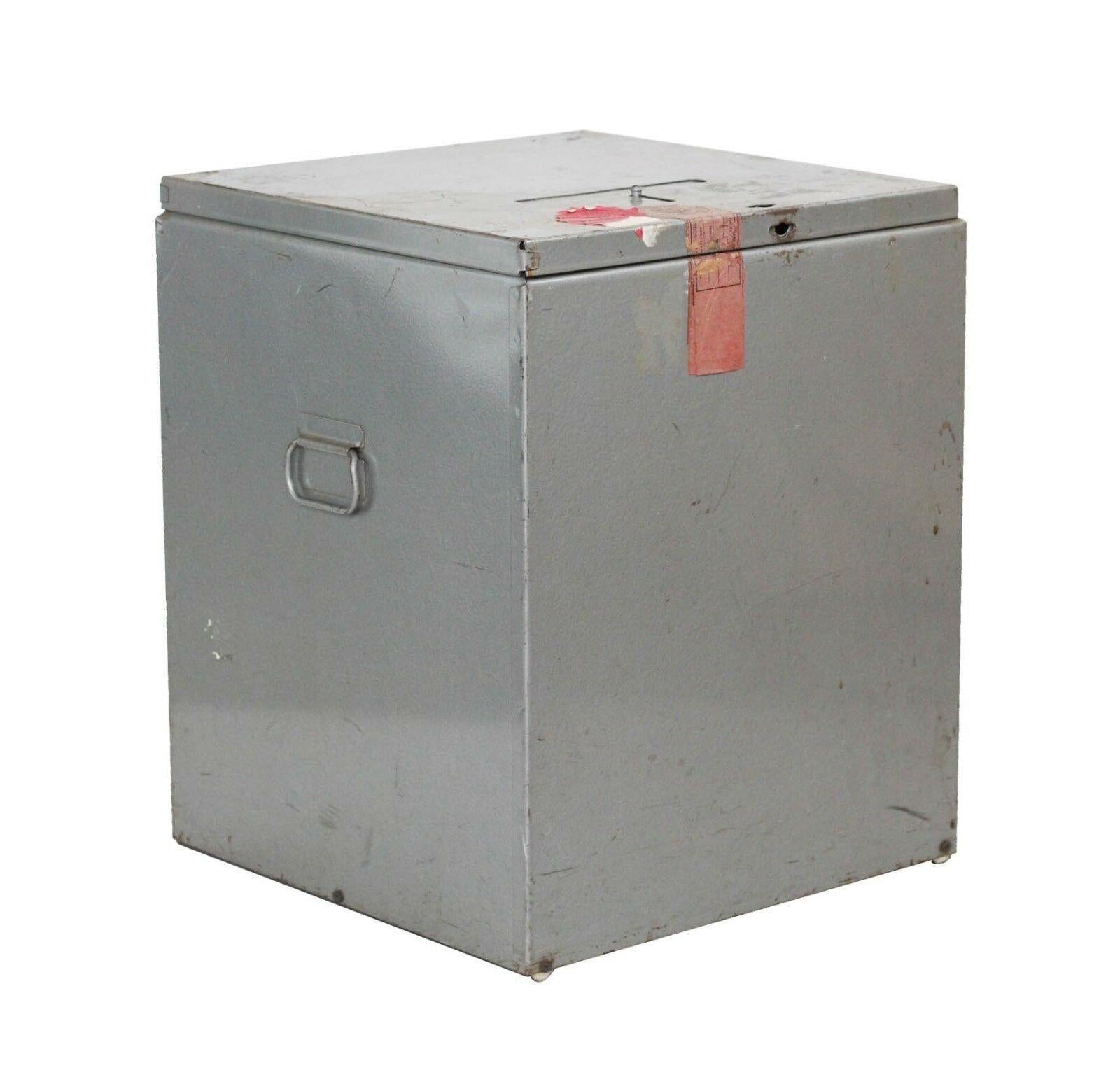 USA, 1990s
Authentic decommissioned ballot box from Kent County, Michigan. Steel construction- industrial grey finish. Retains various original seals and stamps. The slot can be opened or closed; there is a position for the box to be sealed and