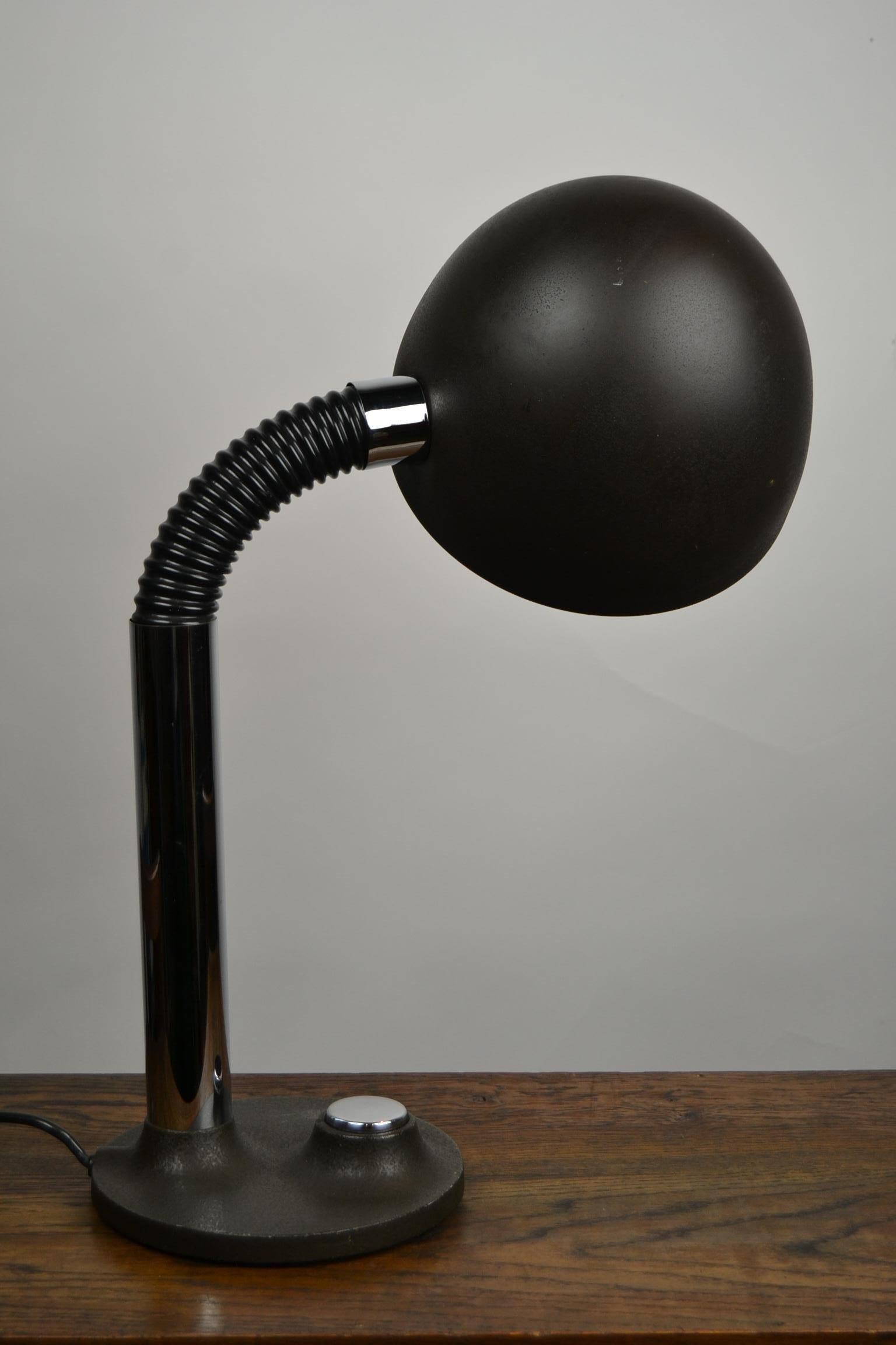 Industrial design desk lamp by Egon Hillebrand for Hillebrand Lighting.
The table lamp has a jointed and flexible arm what makes him functional to shine up, down and to the side.
This 1970s lighting has a organic shaped cast iron base with a large