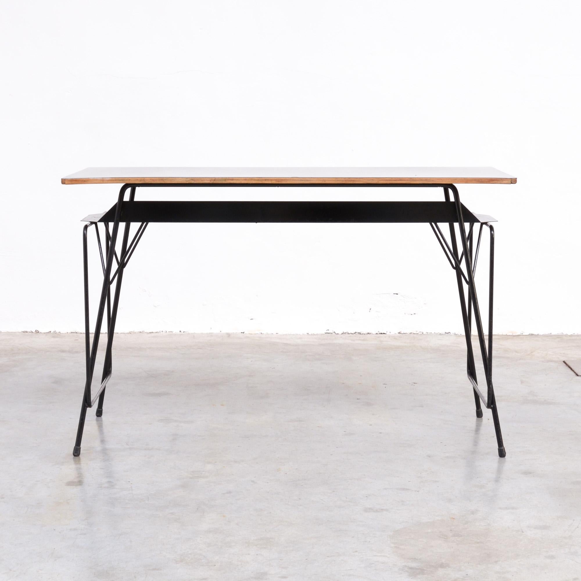 This beautiful desk was designed by Willy Van Der Meeren in the early 1950s and manufactured by Tubax.
Van Der Meeren designed this kind of desks for schools.
The black lacquered metal frame is sophisticated made. The top in natural wood is