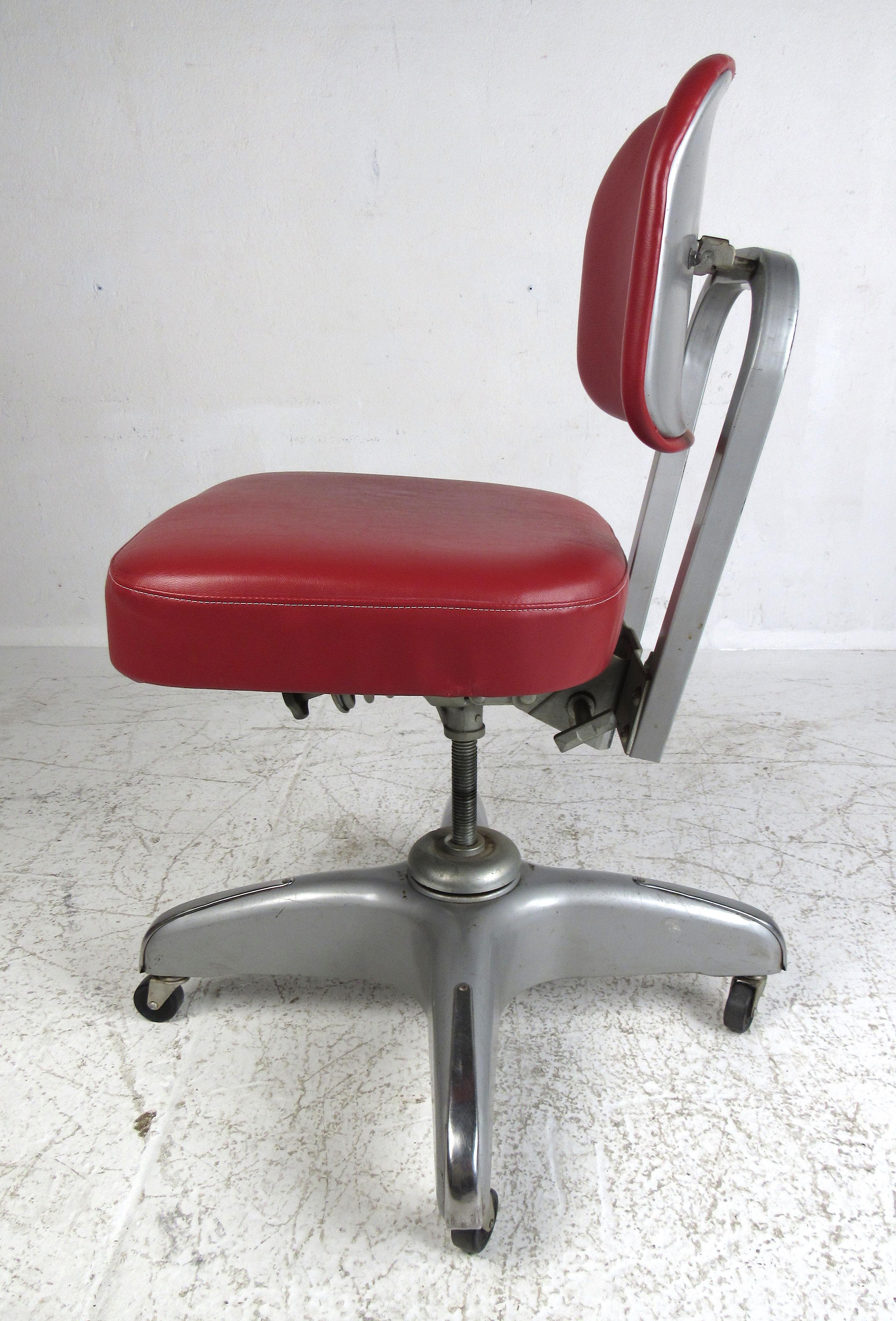Vintage industrial swivel office chair by Cole Steel featuring metal frame with vinyl upholstery and adjustments for height, recline angle, backrest and seat. Please confirm item location (NY or NJ) with dealer.

 The seat height at its lowest point