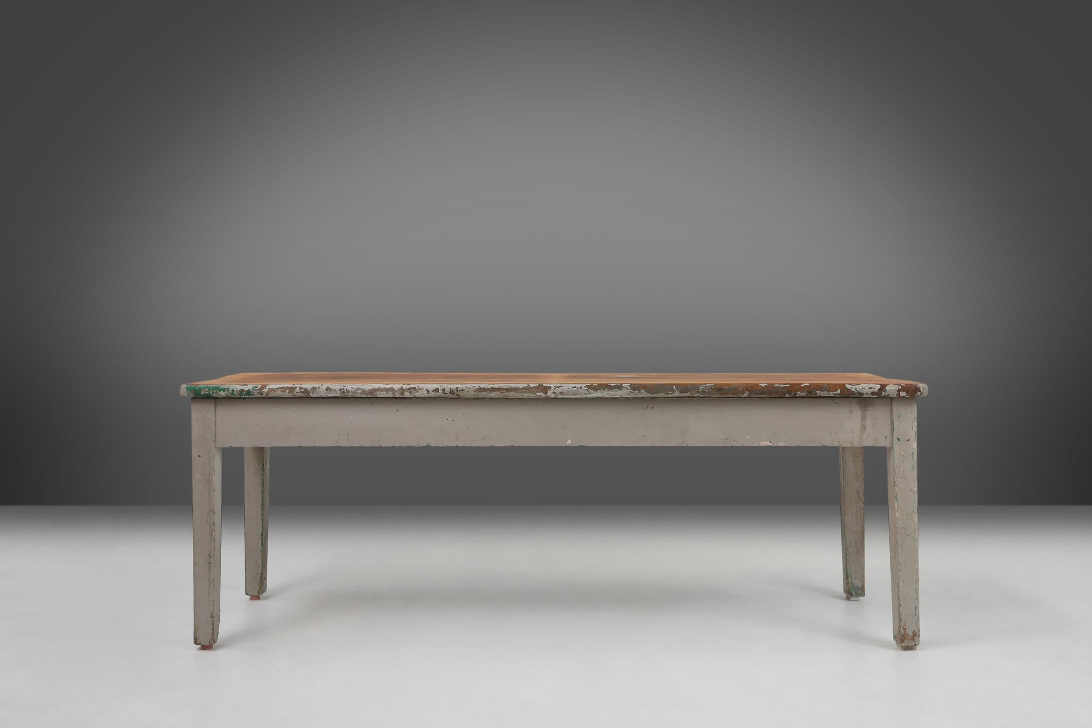 Authentic 1920s industrial table made of full wood exudes a timeless beauty that enriches any room. The beautiful patina on the wood, obtained from old paint residues, adds a unique character to this masterpiece.

With room for four to six chairs,