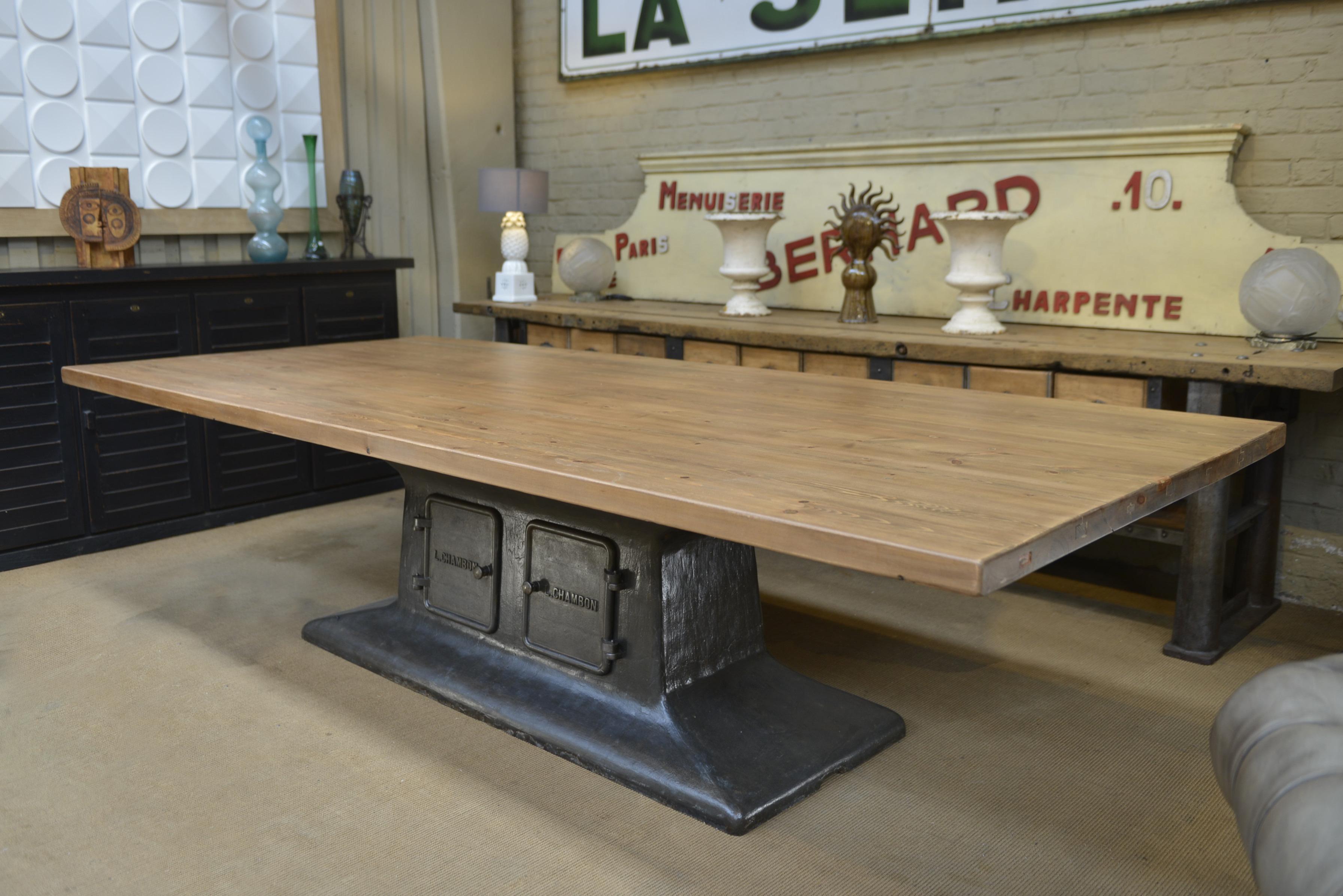 This incredible Industrial dining room table incredible is a L. CHAMBON 2 doors cast iron French wood factory base circa 1920 with Large solid pine top with mat varnish finish. All in very good condition. Weight about 450 kg.
