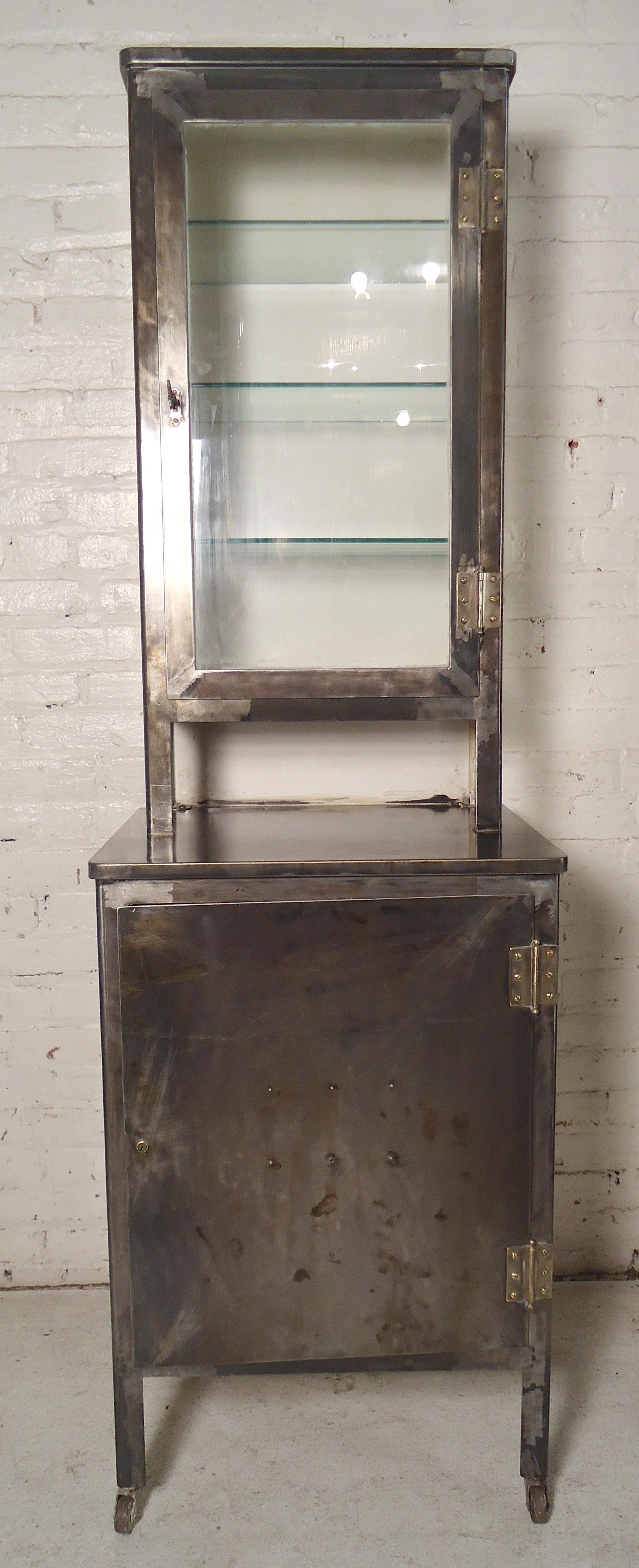 Vintage metal storage unit with glass display cabinet. Restored in a bare metal style finish. 
Top cabinet: 19