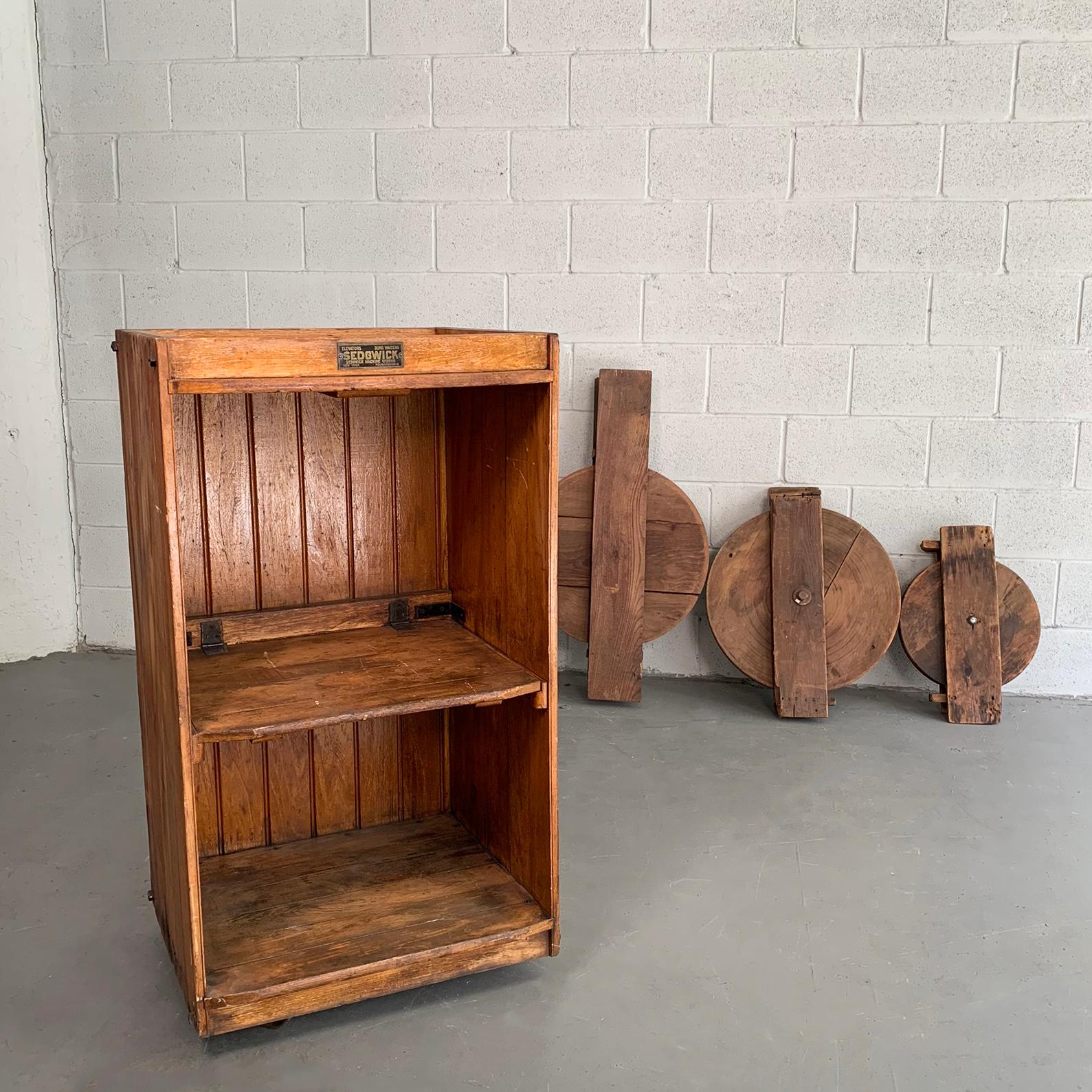Industrial, early 20th century, douglas fir, dumbwaiter cabinet by Sedgewick is a flexible cabinet case for books or display that rolls on casters. The top section is 18.75 inches height and the bottom section is 15.5 inches height. The dumbwaiter