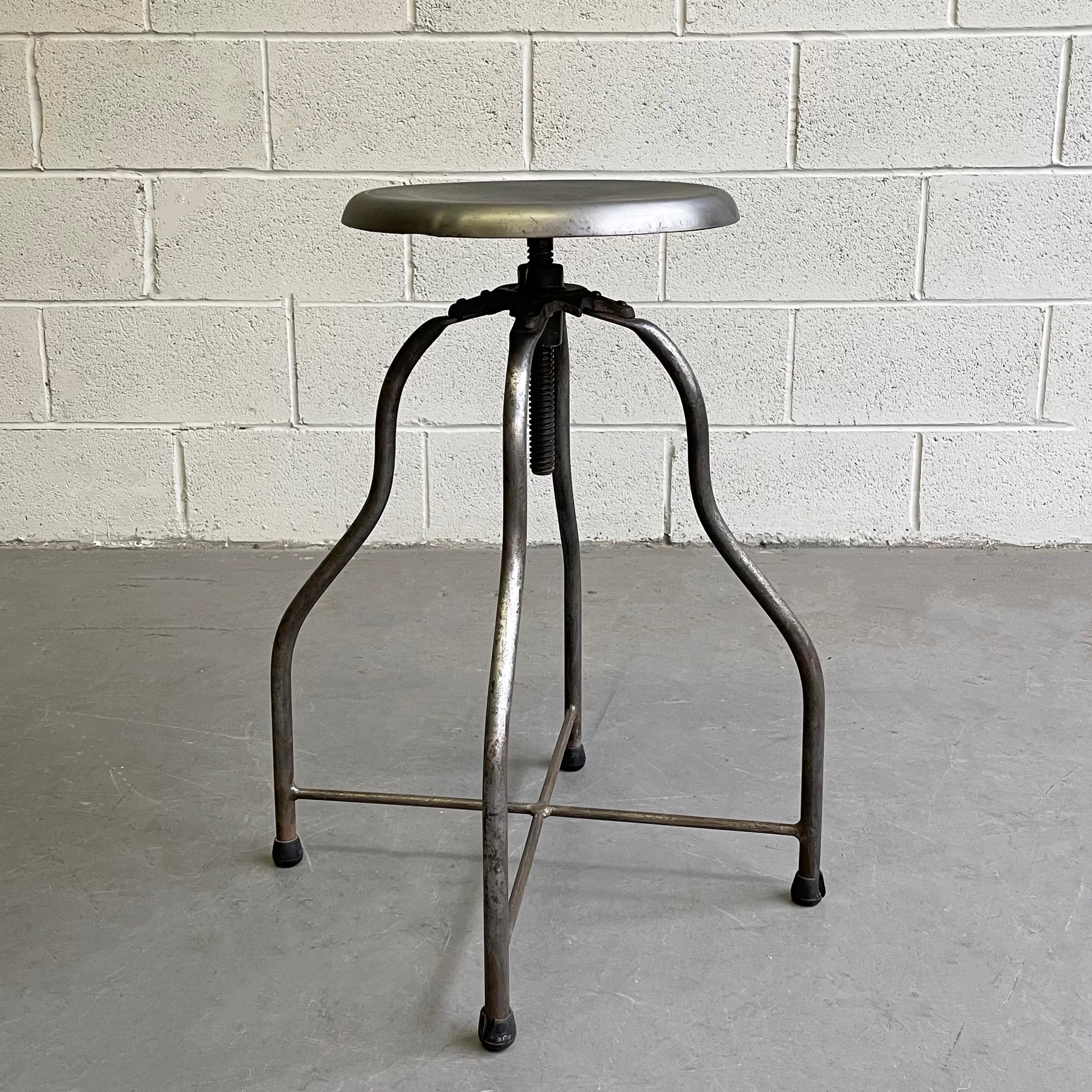 Early 20th century, brushed steel, apothecary, hospital, examination swivel stool is height adjustable from 24 - 30 inches.