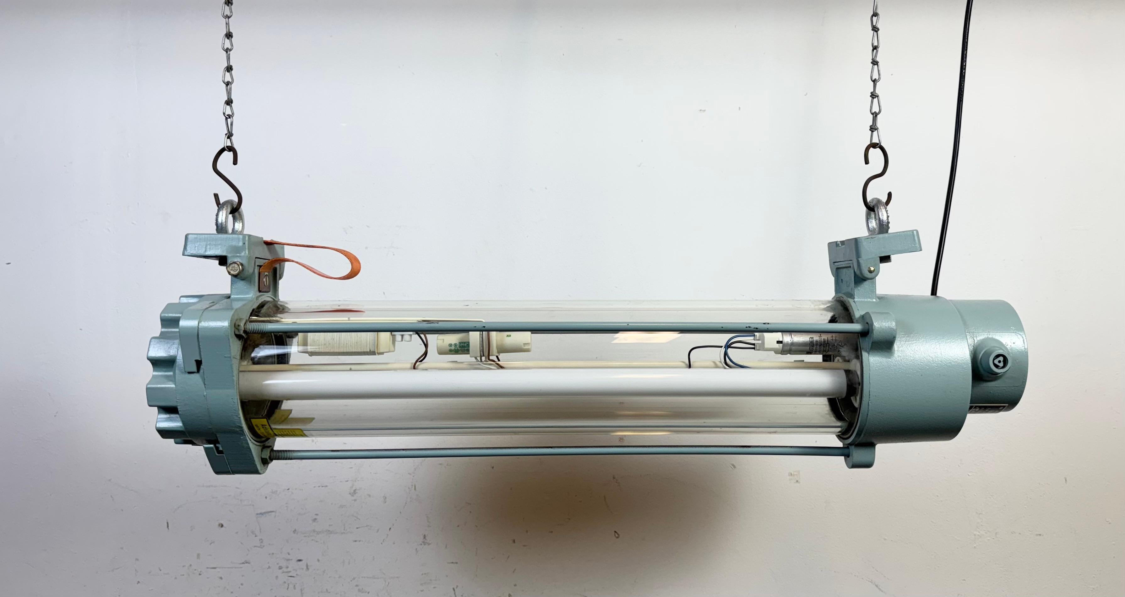Light grey industrial fluorescent tube light made by Leuchtenbau Wittenberg in former East Germany during the 1980s. It is made of an aluminium and glass .The light requires two 60 cm T8 fluorescent tubes .The weight of the lamp is 12,5 kg. The