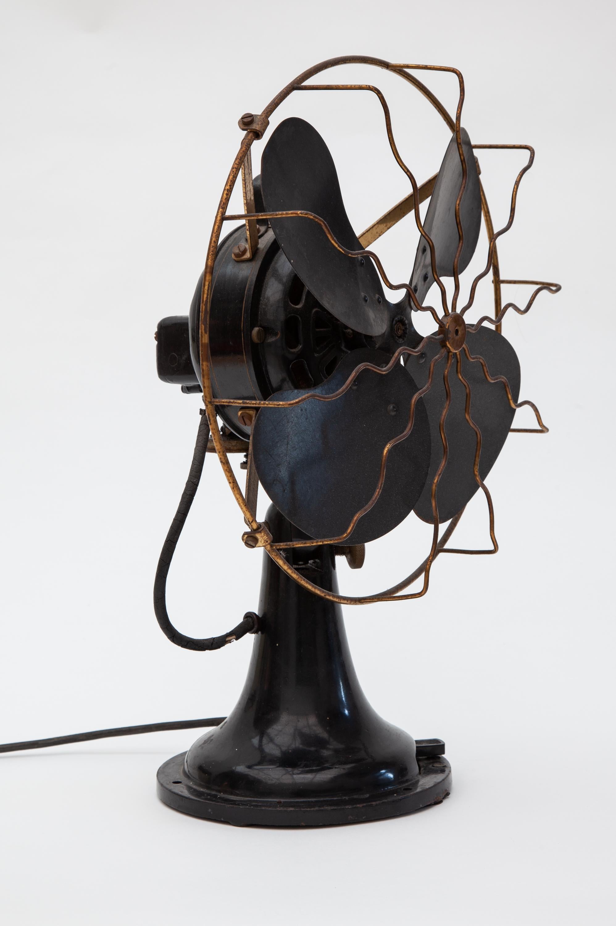 Electric fan manufacture E.M.I. Utrecht Holland.
Black and brass robust industrial fan from the 1930s.E.M.I. Utrecht Holland.
The fan has a cast iron base, enameled and the blades of the fan and the safety grid are made of brass.
 