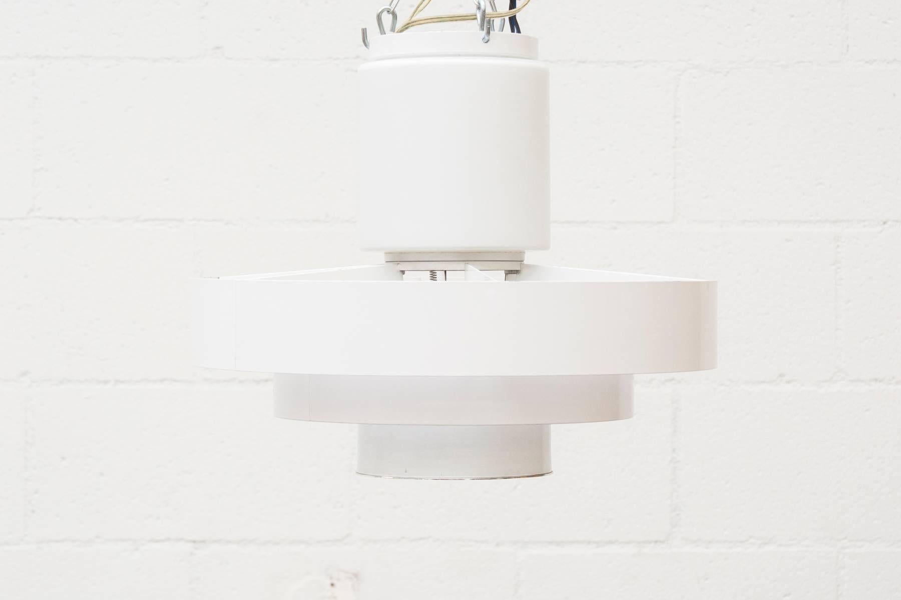 Eye-catching Philips attributed Mid-Century flush mount industrial banded ceiling lamp outfitted with an opaline glass upper shade and a lower enameled metal shade with an inset reflector for spot light. A wonderful example of clean mid-century