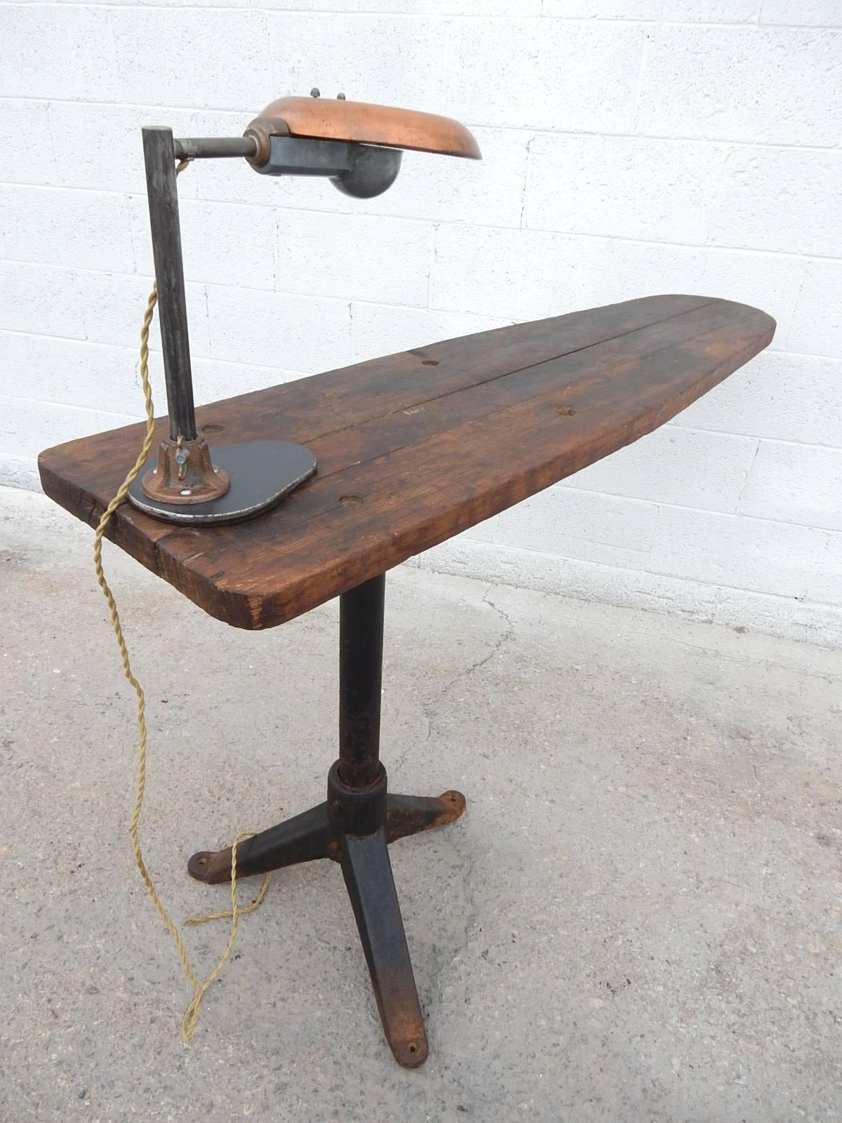 Unique Industrial era adjustable cantilever wood and iron work table with original Avant Garde inspection lamp.
From a tailors shop in the warehouse district of Kansas City, MO.
This set would be a perfect computer desk or console table. Lamp not