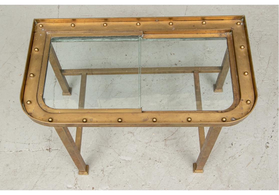 Well-crafted occasional/ coffee table made from a vintage ships window from the early 1930s or possibly earlier. Very well done and stylish with a beaded window surround and handsome capped legs. Solid construction and has age/use related marks,