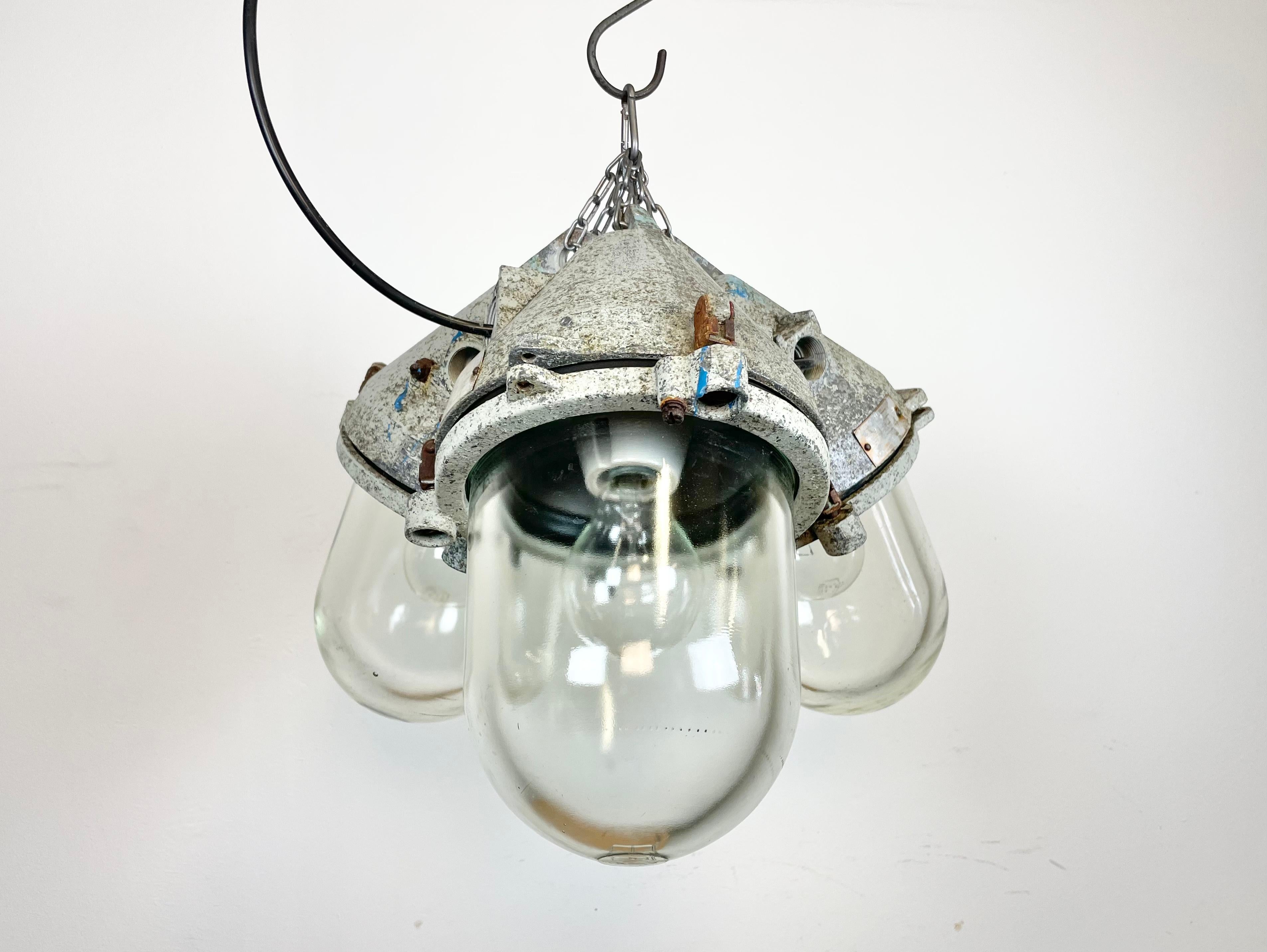 Industrial chandelier made from three Elektrosvit cast aluminium lamps with explosion proof glass in former Czechoslovakia during the 1970s.The weight of the chandelier is 15 kg.