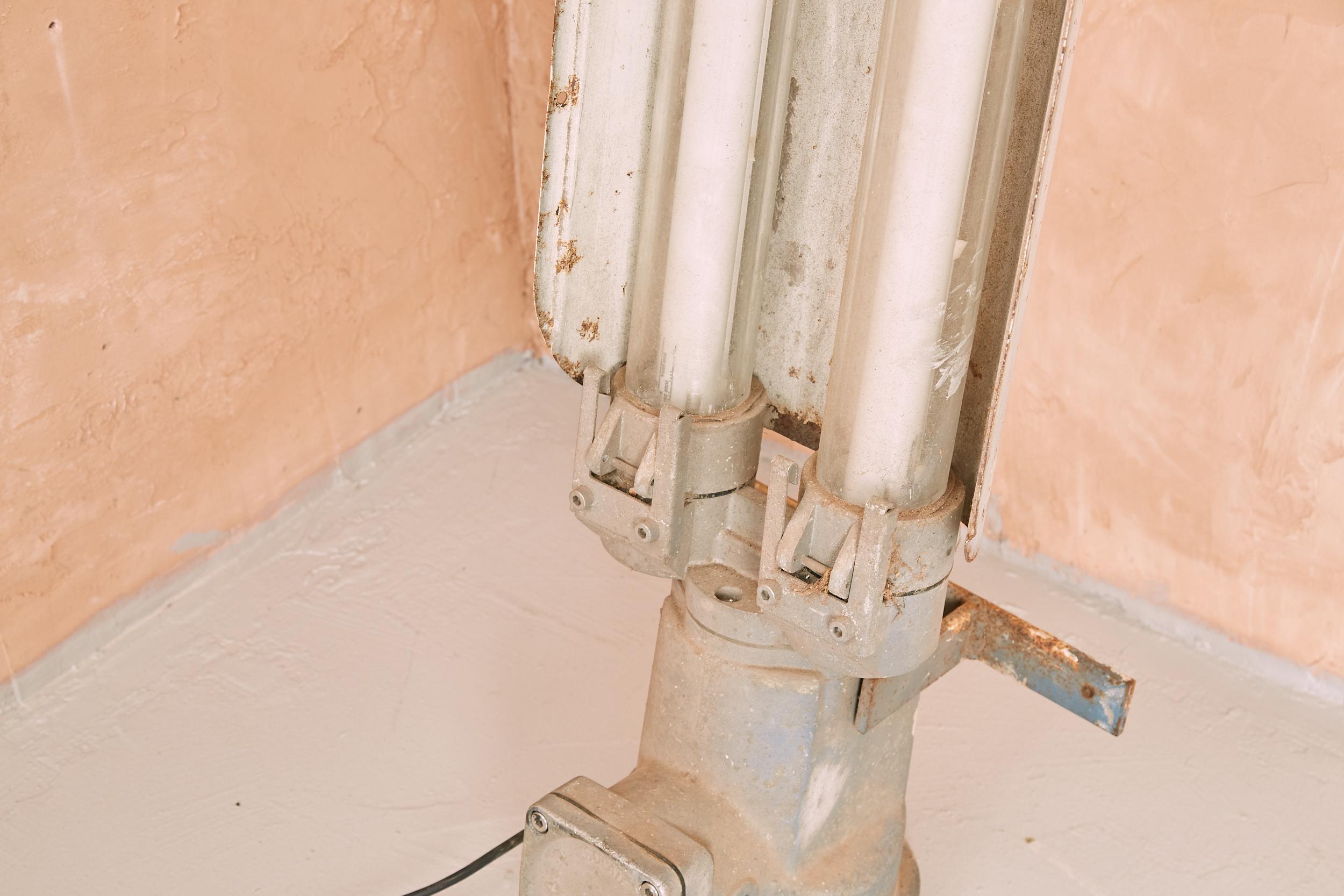 A Thorn FLP explosion proof lamp with shade built in.
Works exceptionally well as a floor standing lamp but can also be hung as originally intended.
In full working order with original patina still in tact. 
A very heavy industrial item with a