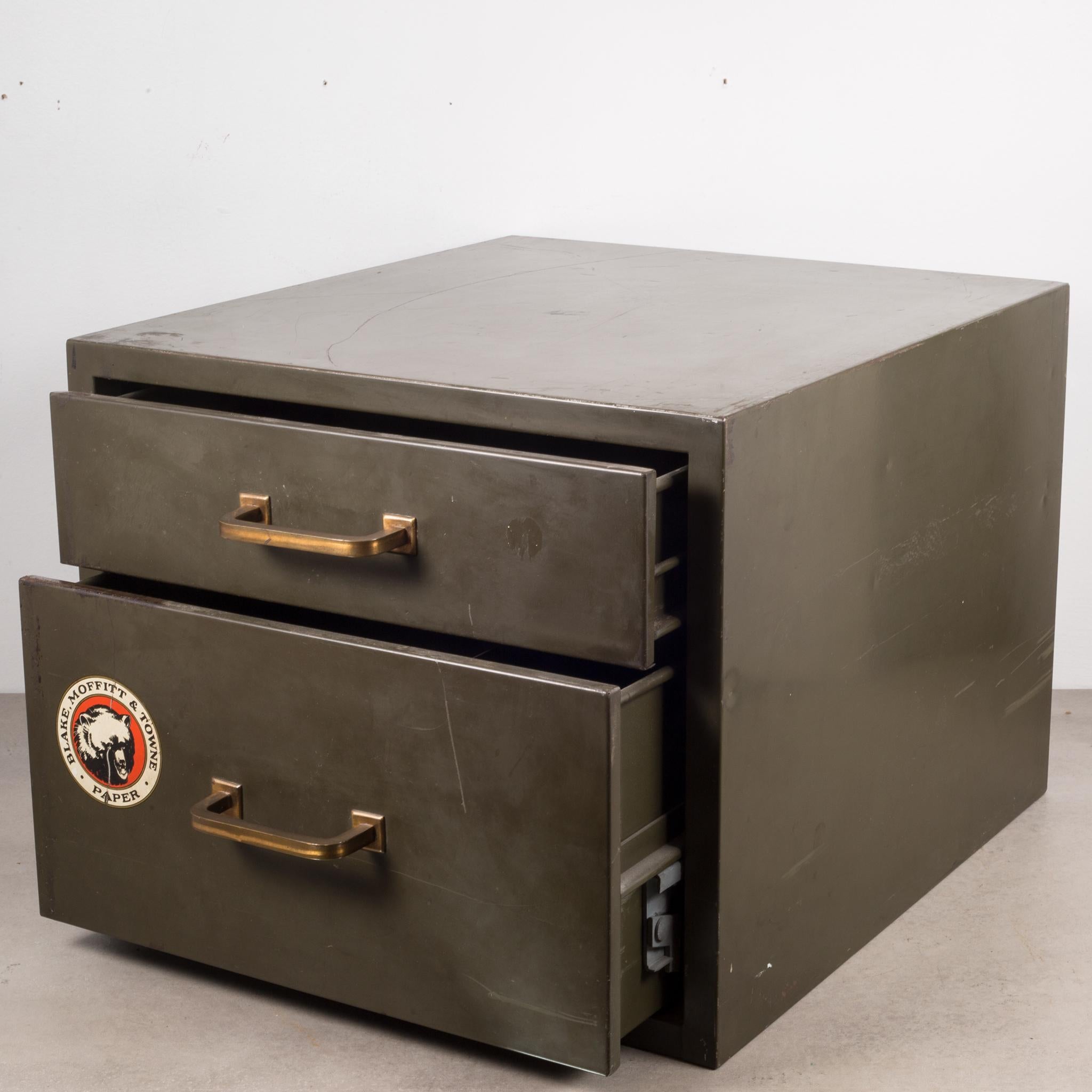 About:

An army green Industrial factory two drawer metal cabinet with original label, brass pulls and bottom segmented drawer. Solidly built with easy gliding drawers.

Creator: Unknown.
Date of manufacture: circa 1940.
Materials and