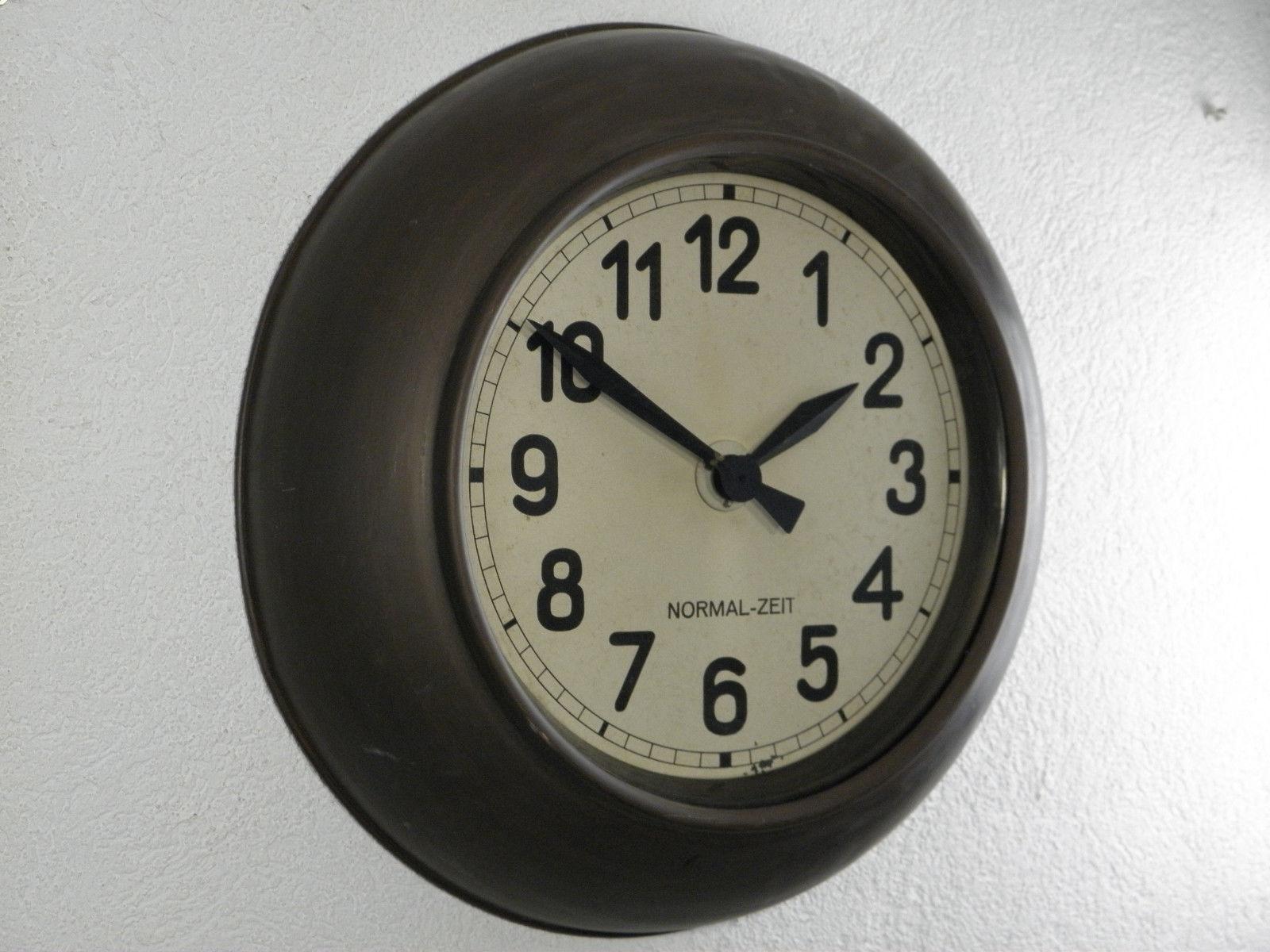 Industrial wall clock made in the 1930s by Normal-Zeit later TN company. Frame made of a brass. The clock face is covered with glass. Formerly a slave clock, it is now fitted with a modern quartz movement with an AA-battery.
