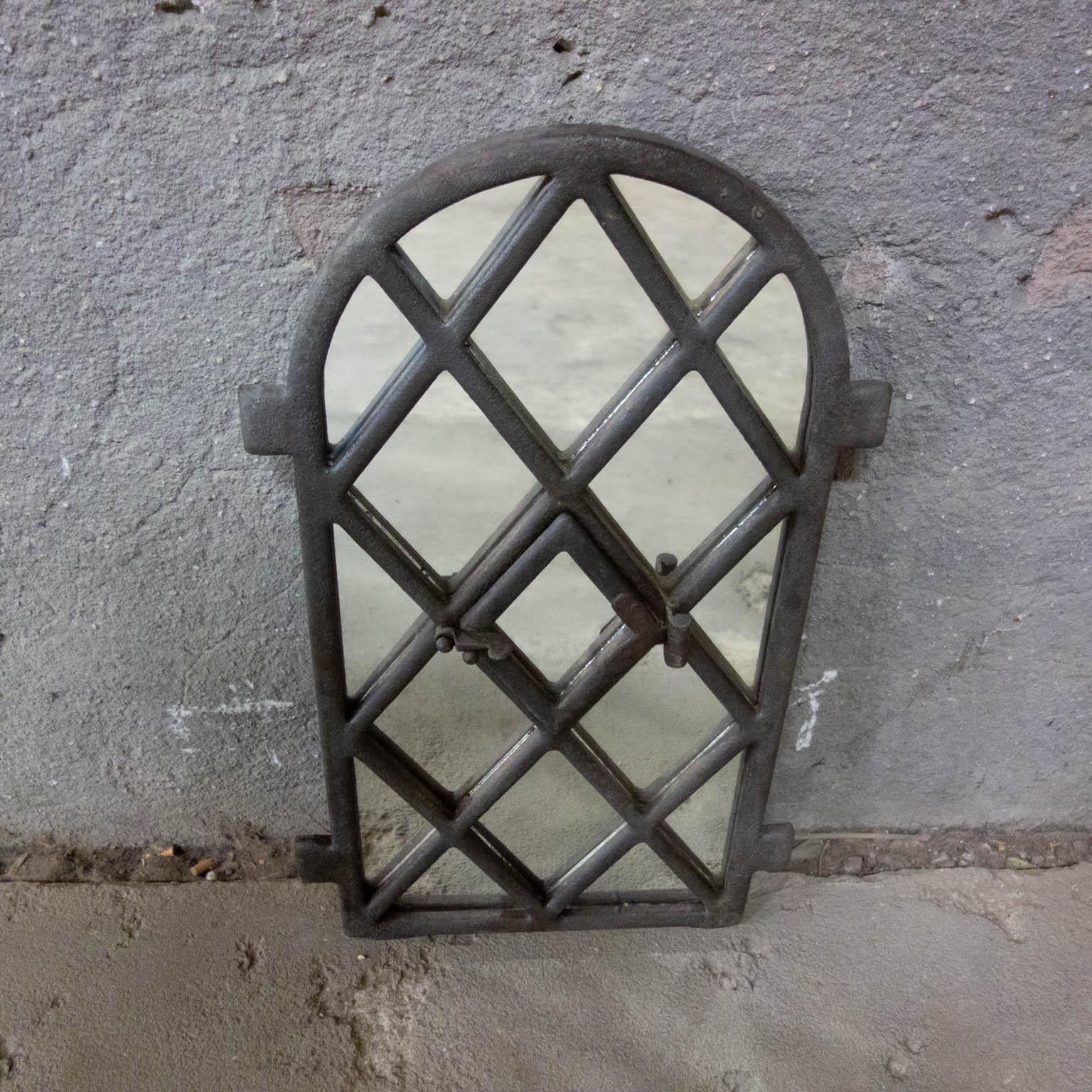 This decorative mirror is made from an old window frame of a farm. The mirror even has a small hatch in the middle window.